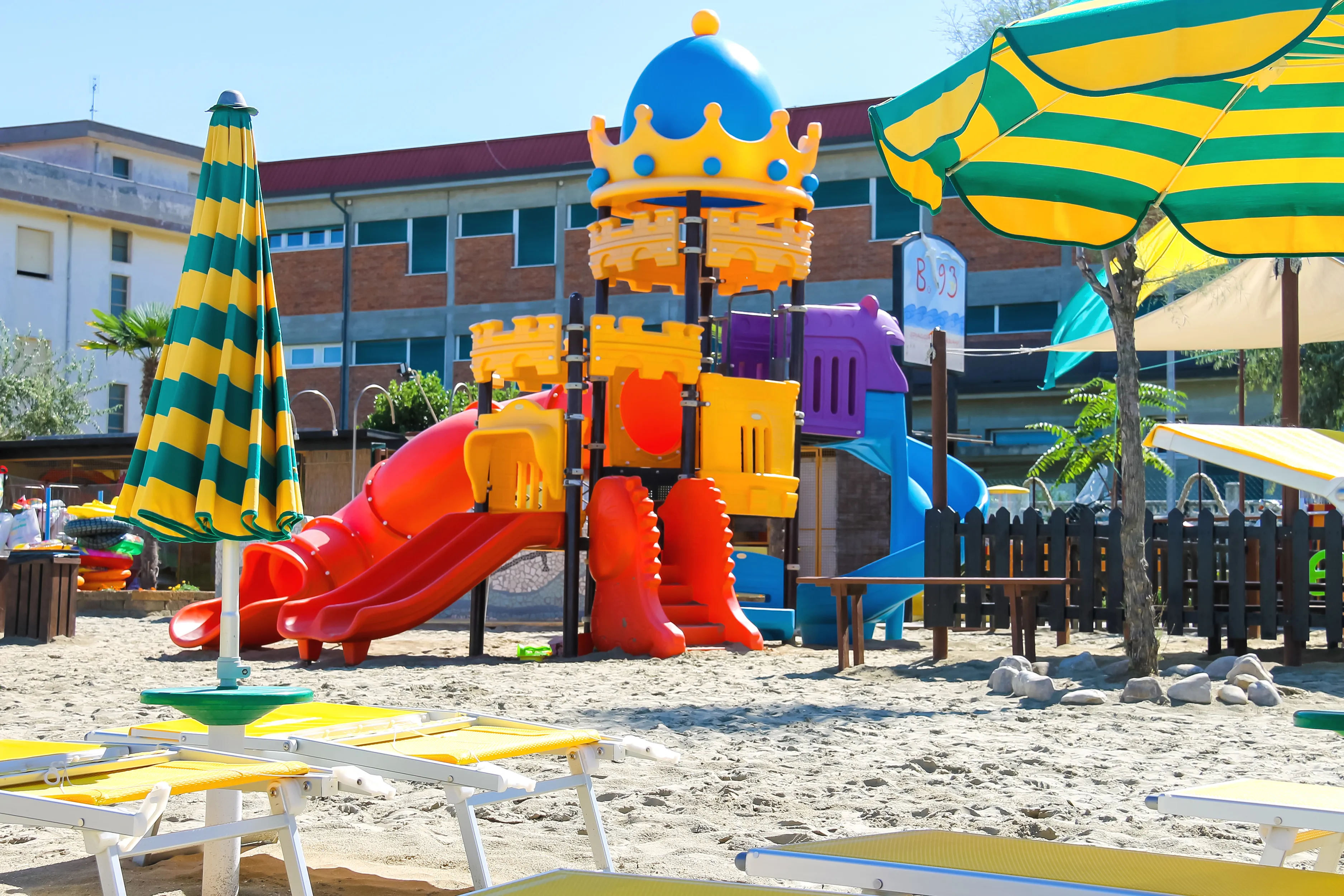 Children's playground, beach chairs and umbrellas on the beach in the resort town Bellaria Igea Marina, Rimini, Italy