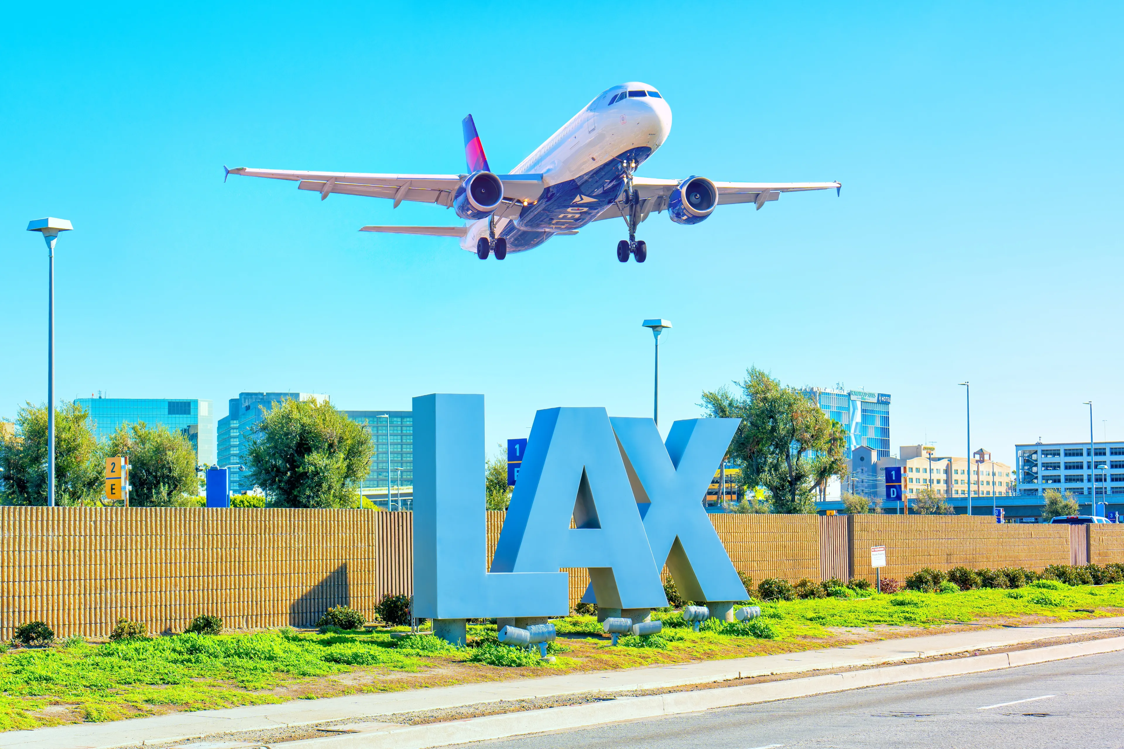 Los Angeles, California - February 1, 2023: Delta Airlines plane takes off over the iconic LAX sign at Los Angeles International Airport