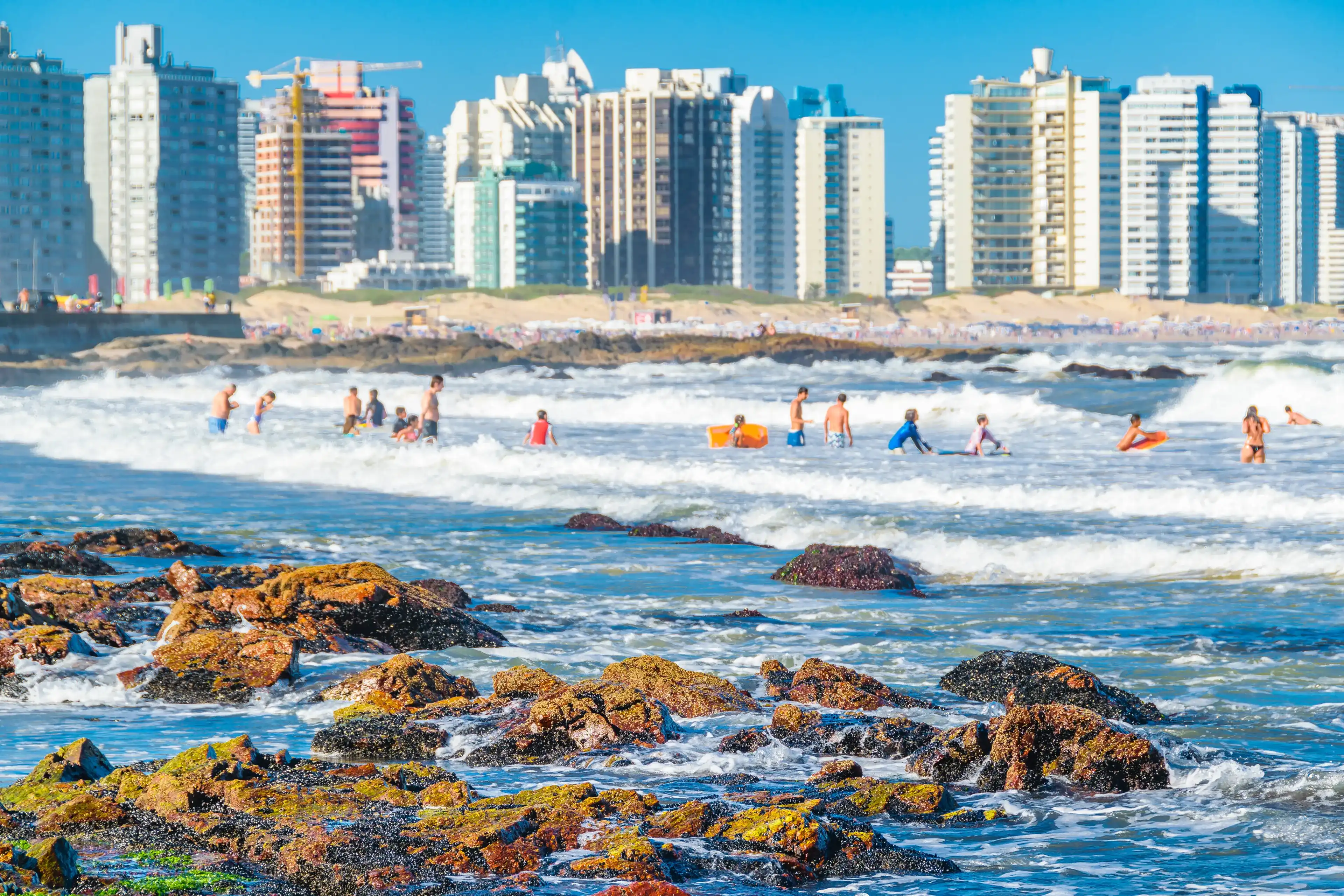 PUNTA DEL ESTE, URUGUAY, FEBRUARY - 2020 - People bathing at famous brava beach in punta del este city, Uruguay