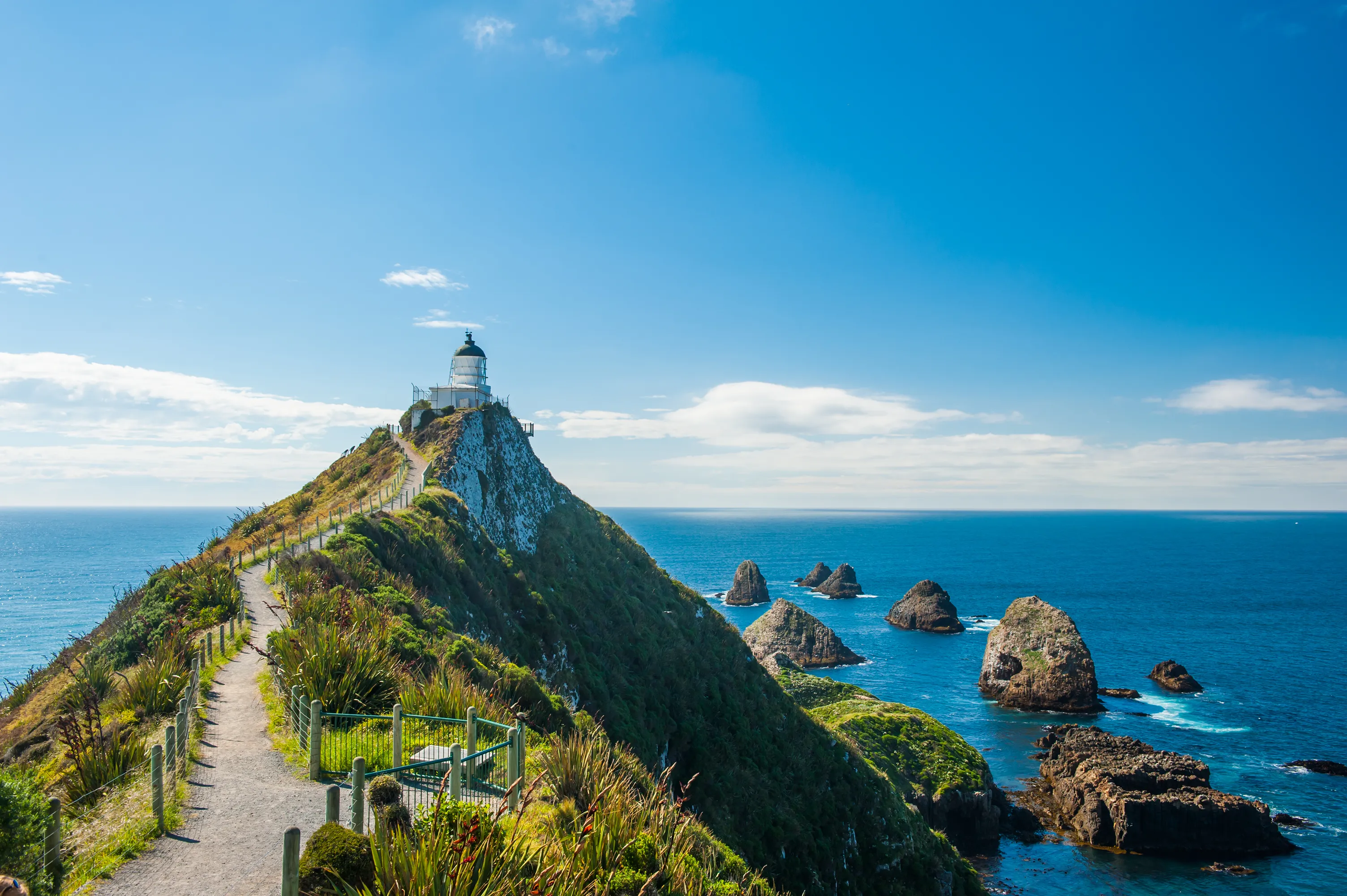 Lighthouse on Nugget Point. It is located in the Catlins area on the Southern Coast of New Zealand, Otago region. The Lighthouse is surrounded by small rock islands, nuggets