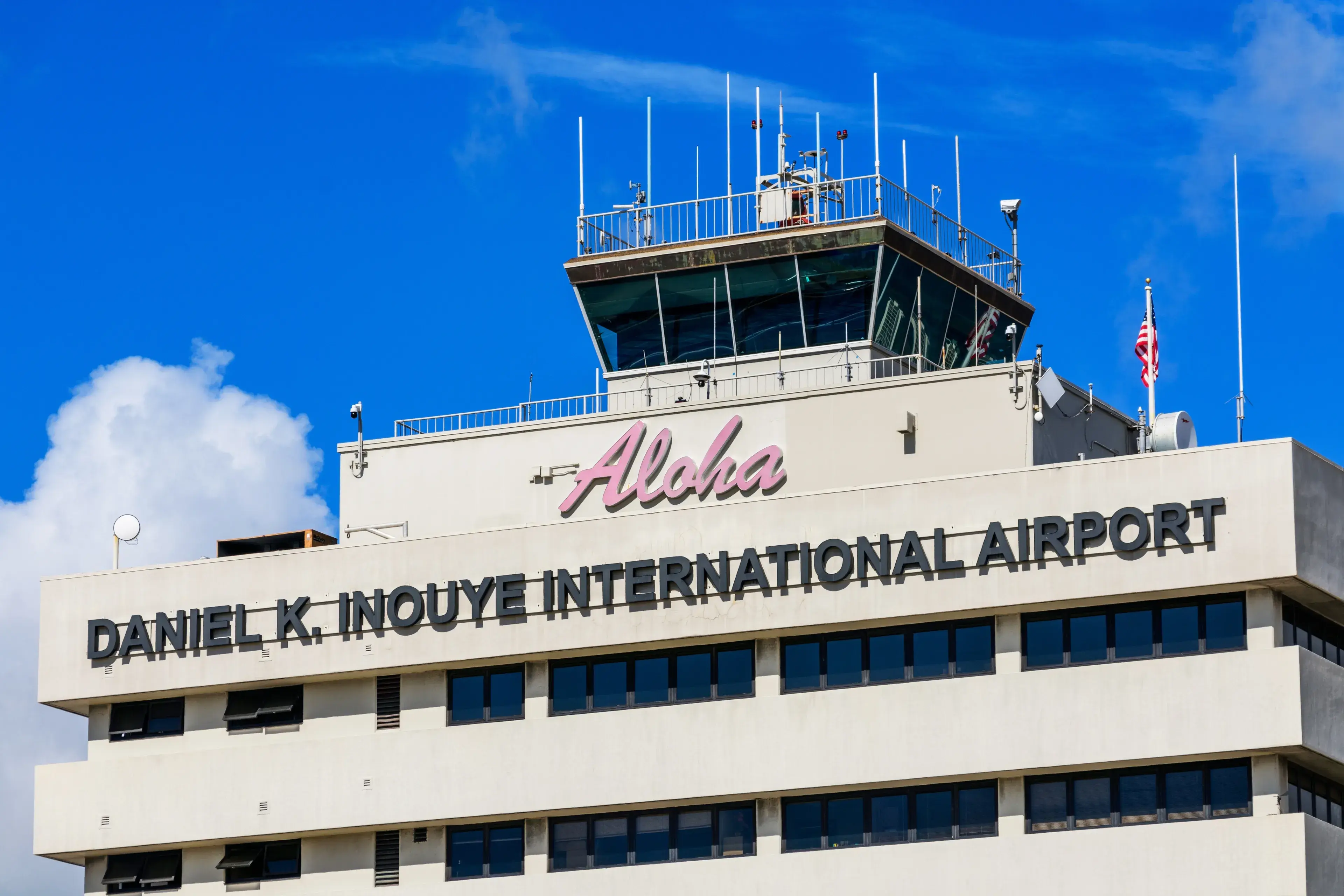Daniel K. Inouye International Airport sign on building tower facade of HNL Honolulu International Airport. - Honolulu, Hawaii, USA - 2022 Daniel K. Inouye International Airport sign on building tower facade of HNL Honolulu International Airport. - Honolulu, Hawaii, USA - 2022