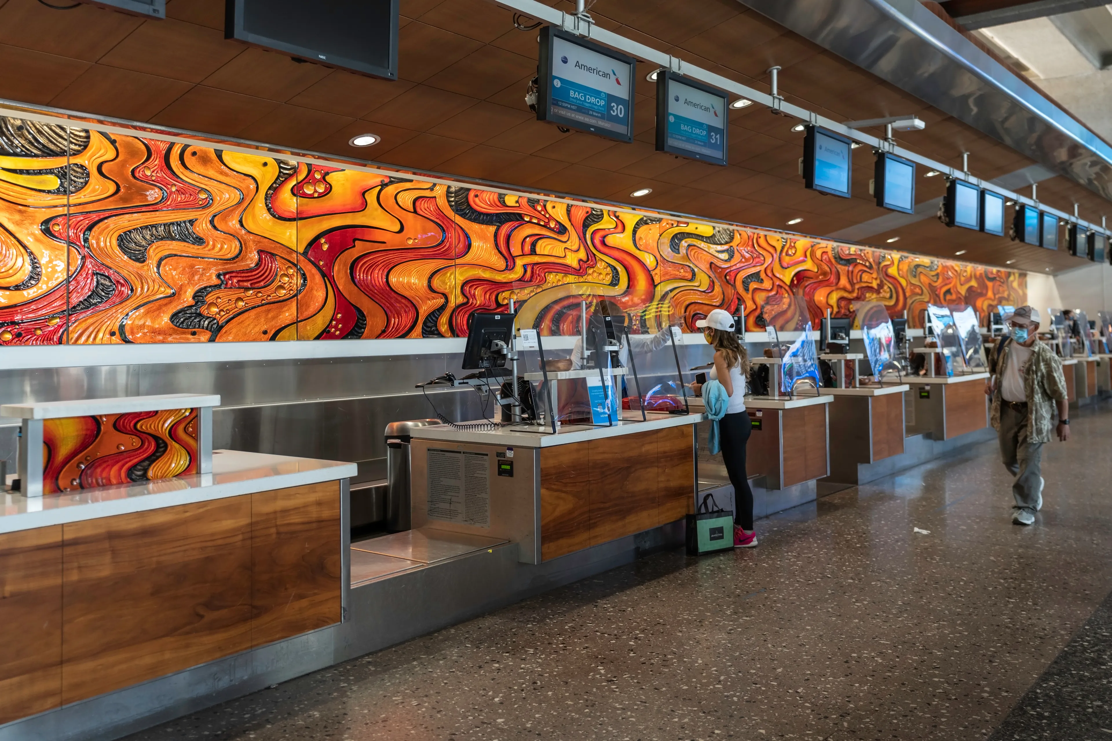 HONOLULU, UNITES STATES - MARCH 2021 : Travelers on empty airport terminal, Daniel K. Inouye International Airport in Hawaii, Oahu Island during pandemic