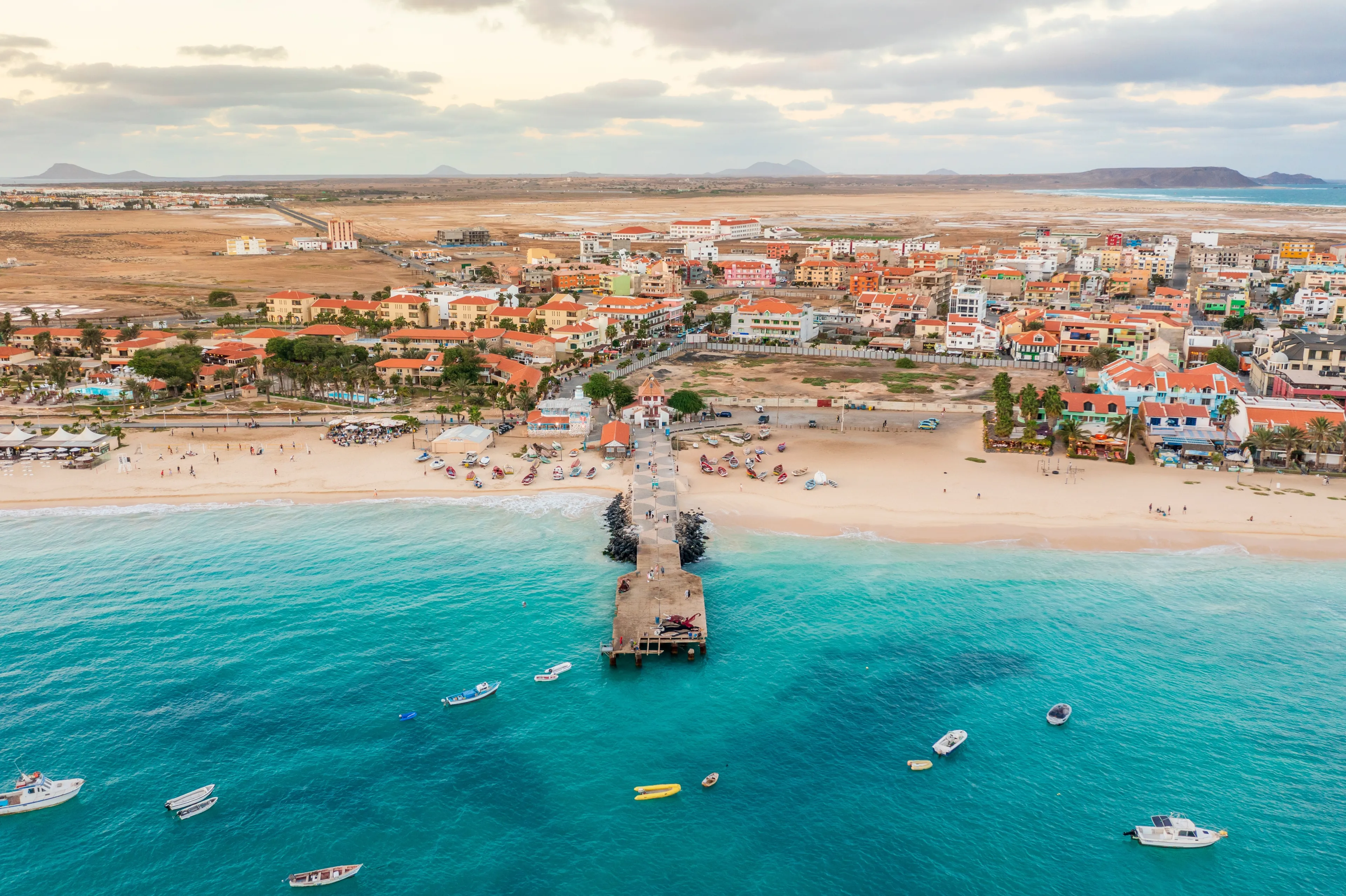 Pier and boats on turquoise water in city of Santa Maria, Sal, Cape Verde