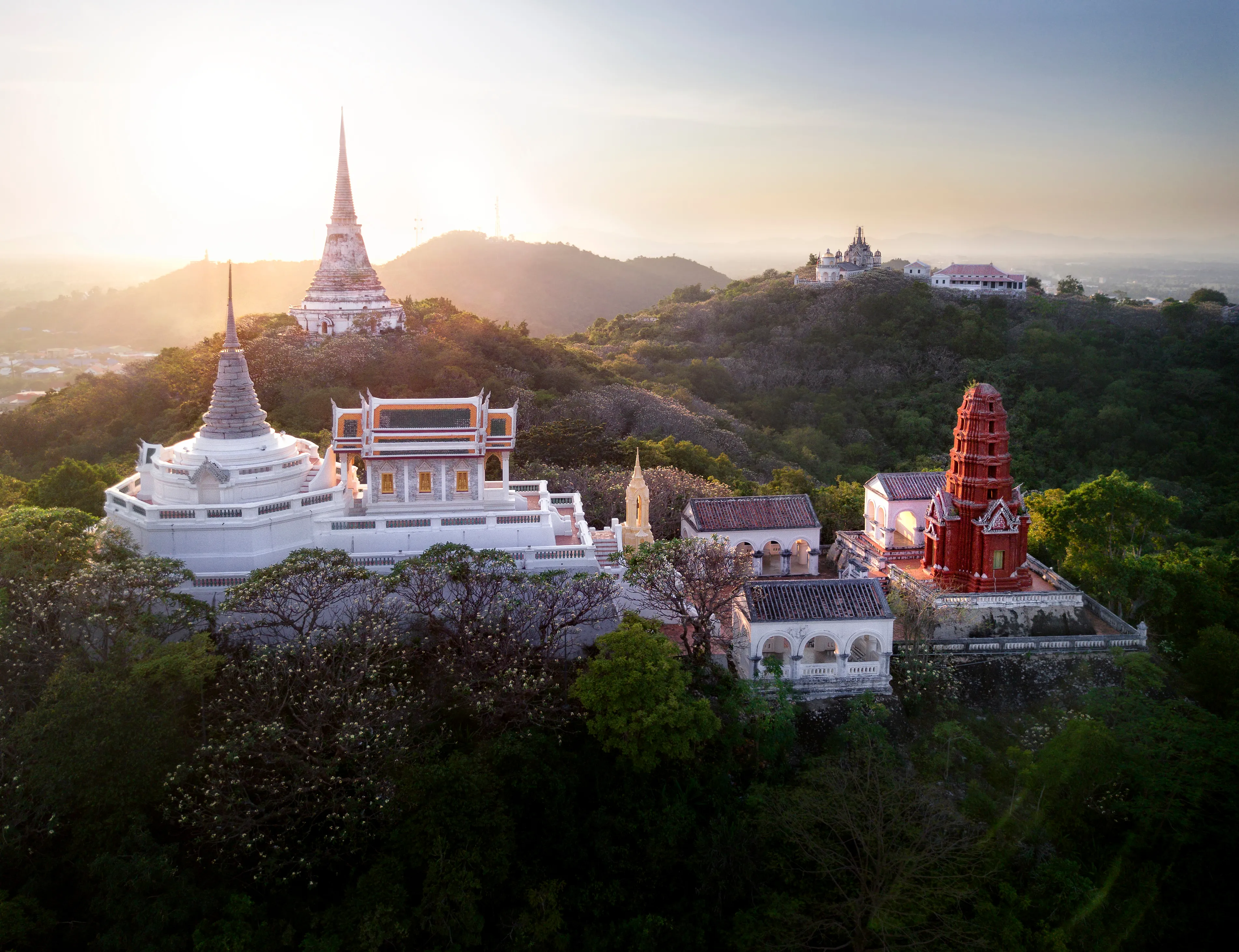 Aerial photo of Phra Nakhon Khiri ( Khao Wang ), the hilltop summer palace of Thai King Rama IV, with sunset in the background. Phetchaburi, Thailand. 