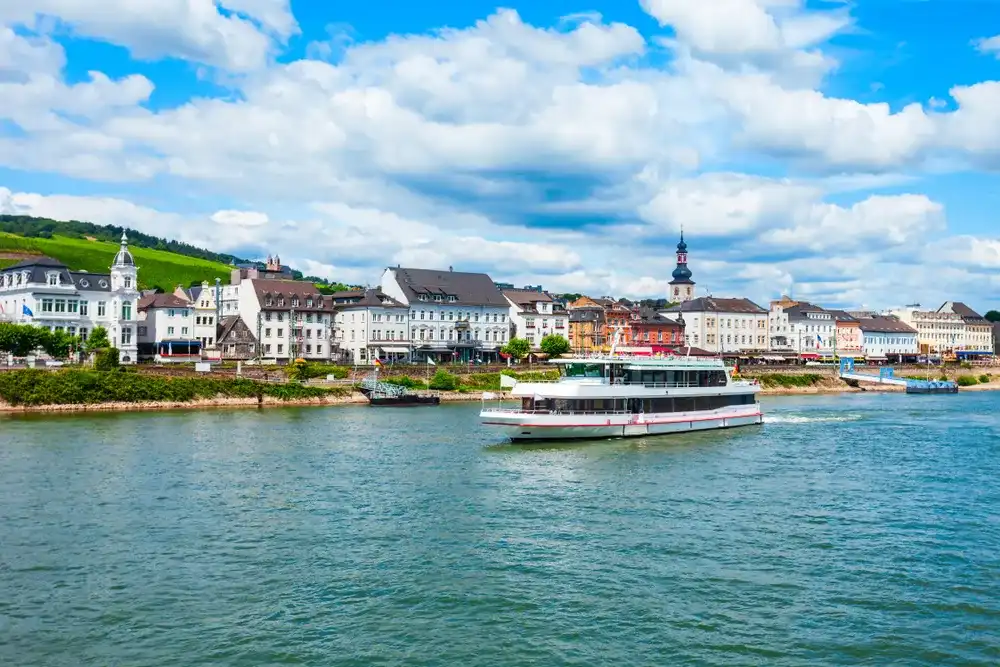 Tourist cruse boat near the Bingen am Rhein town at the Rhine valley in Germany Tourist cruse boat near the Bingen am Rhein town at the Rhine valley in Germany