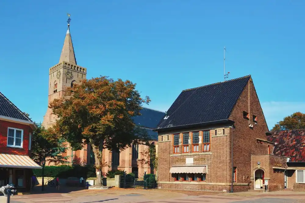Den Burg, Texel / Netherlands - August 2019: Marketplace in city center of town Den Burg with old brick stone buildings and protestant church with clock tower Den Burg, Texel / Netherlands - August 2019: Marketplace in city center of town Den Burg with old brick stone buildings and protestant church with clock tower