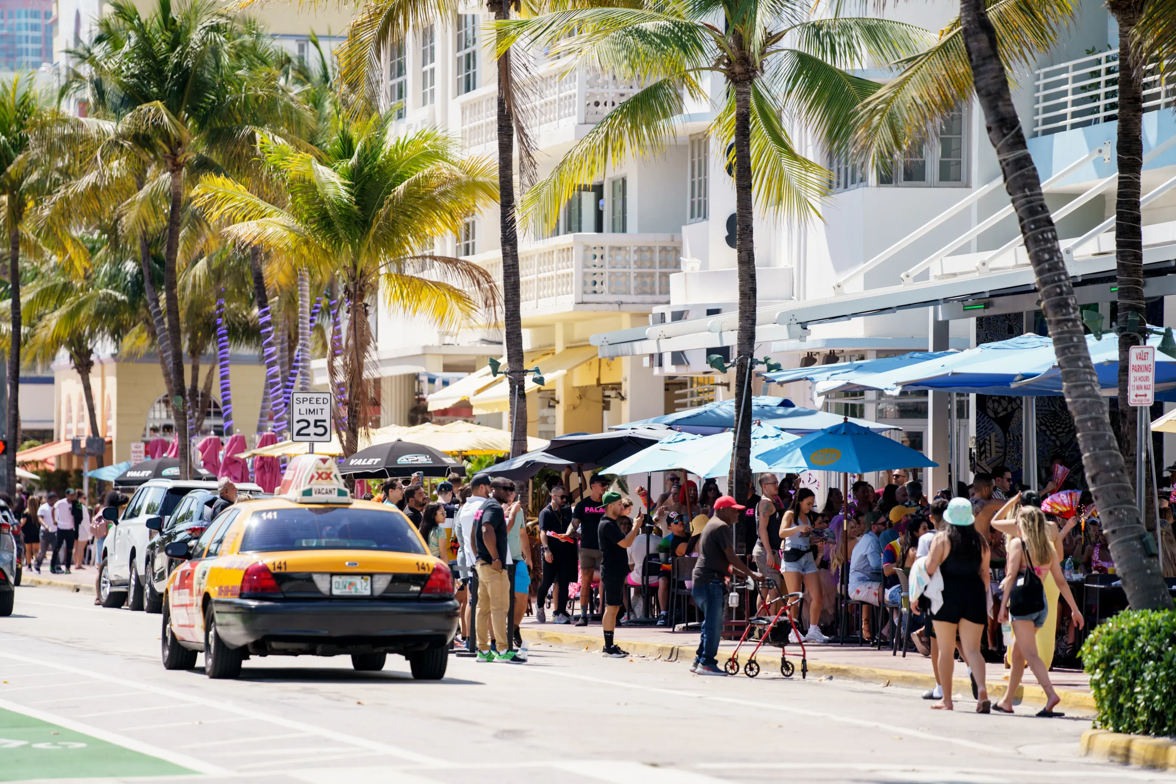 Miami Beach, FL, USA - March 12, 2022: Scene on Ocean Drive showing crowds of tourists visiting for Spring Break vacation holiday Miami Beach, FL, USA - March 12, 2022: Scene on Ocean Drive showing crowds of tourists visiting for Spring Break vacation holiday