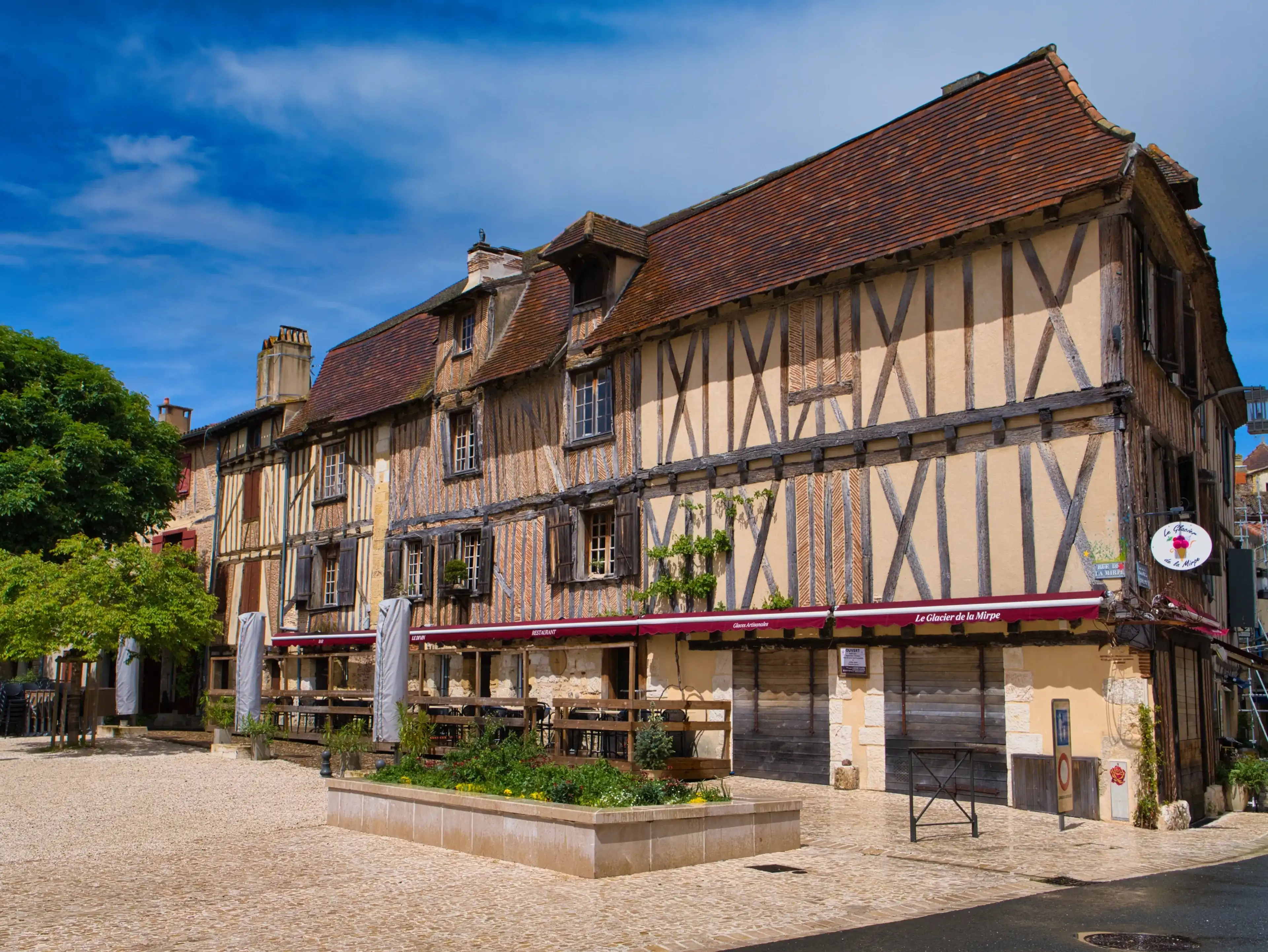 Bergerac, France - May 2 2024: The half-timbered building of the Glacier de la Mirpe in the Place de la Mirpe, Bergerac, in the Dordogne region of France. Taken on a sunny day with a blue sky. Bergerac, France - May 2 2024: The half-timbered building of the Glacier de la Mirpe in the Place de la Mirpe, Bergerac, in the Dordogne region of France. Taken on a sunny day with a blue sky.