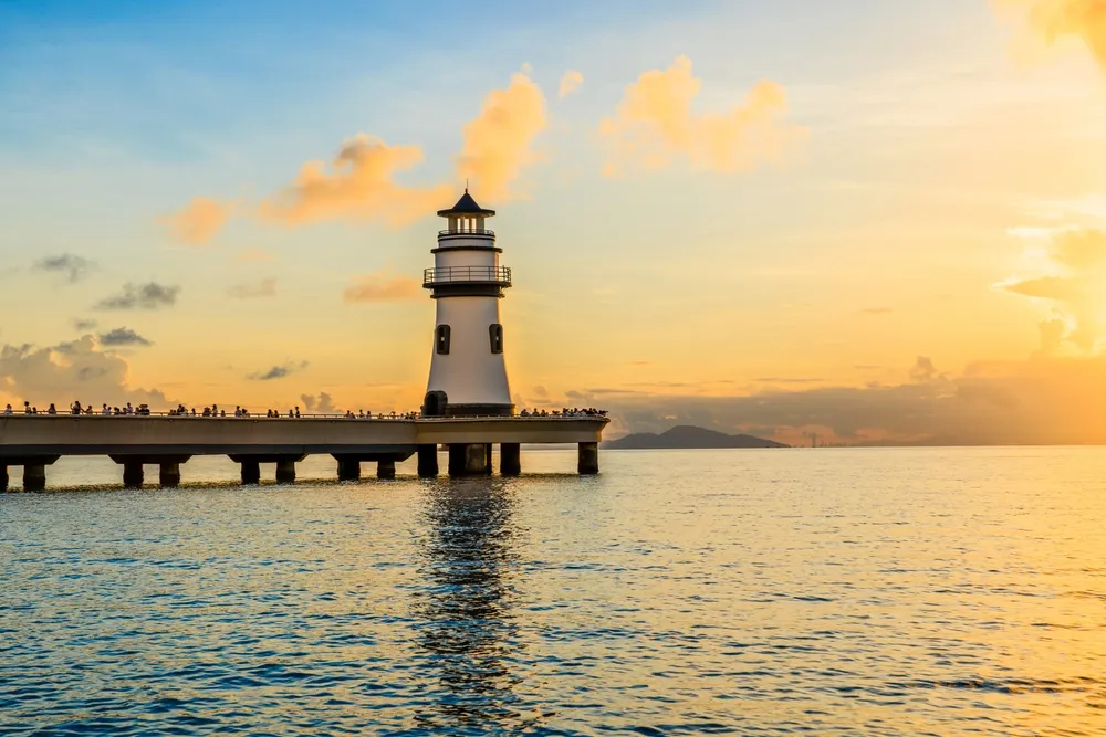 Beautiful lighthouse and coastline natural landscape at sunrise in Zhuhai, Guangdong Province, China.