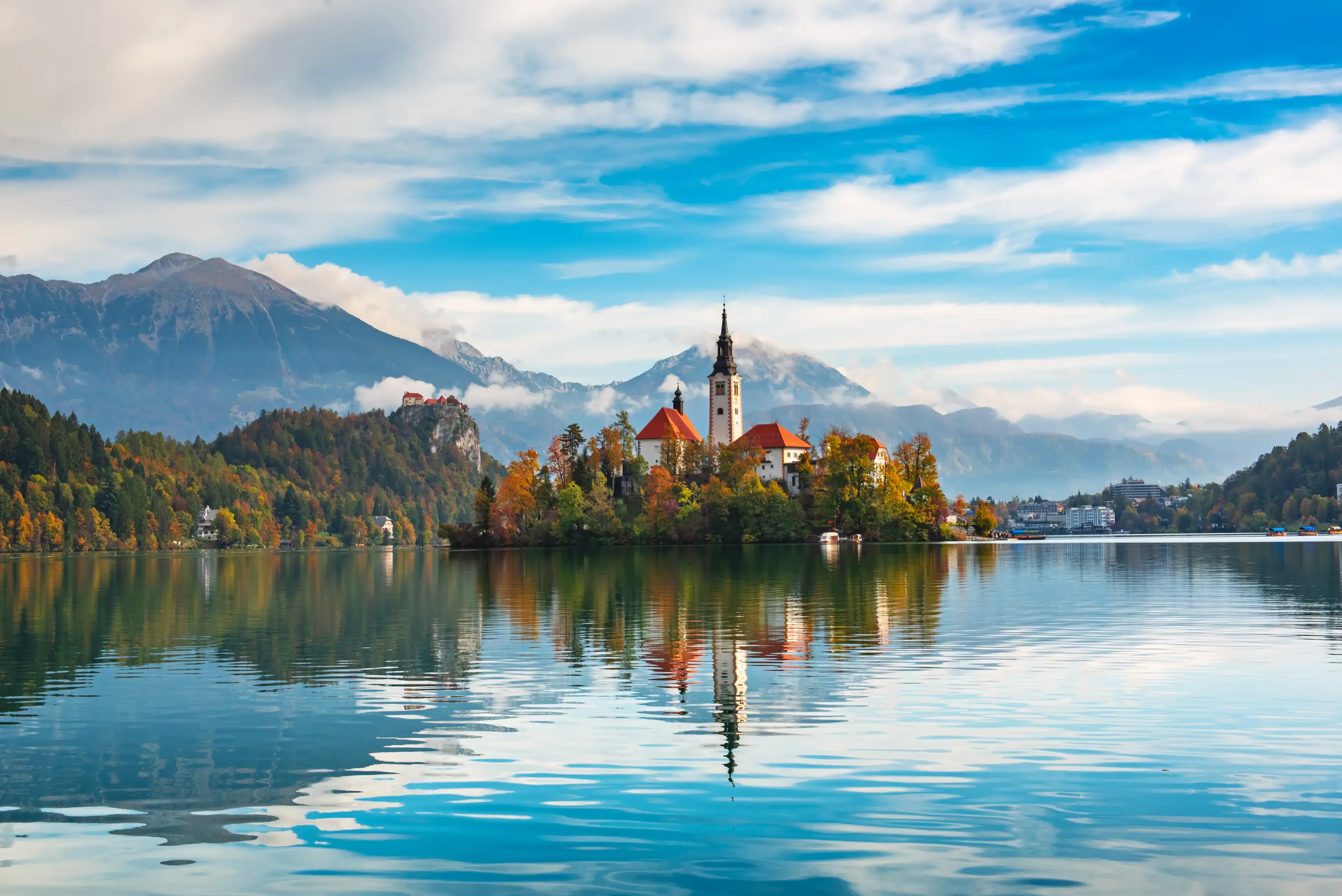 Church of Assumption in Lake Bled, Slovenia with blue sky and clouds in the autumn