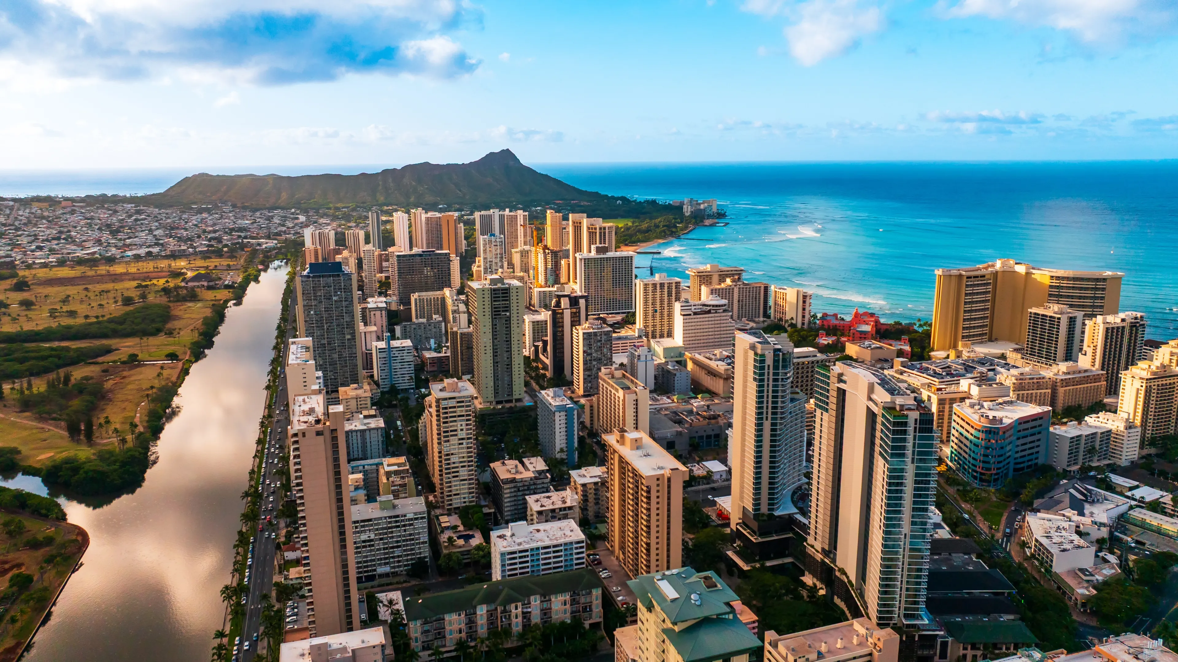 Modern high-rise downtown of Honolulu, Hawaii, USA. Diamond Head Crater at backdrop. Aerial view.