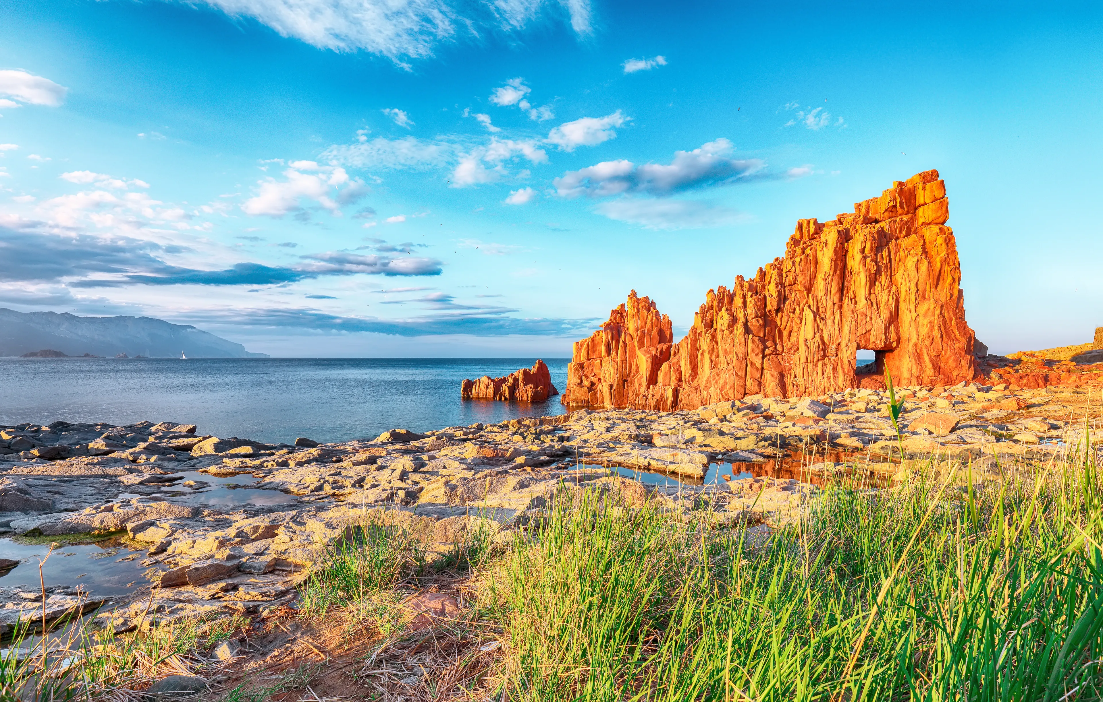 Awesome sunset view of Red Rocks (called "Rocce Rosse") in Arbatax. Location: ArbAwesome sunset view of Red Rocks (called "Rocce Rosse") in Arbatax. Location: Arbatax, Province of Ogliastra, Capo Bellavista, Sardinia, Italy, Europeatax, Province of Ogliastra, Capo Bellavista, Sardinia, Italy, Europe