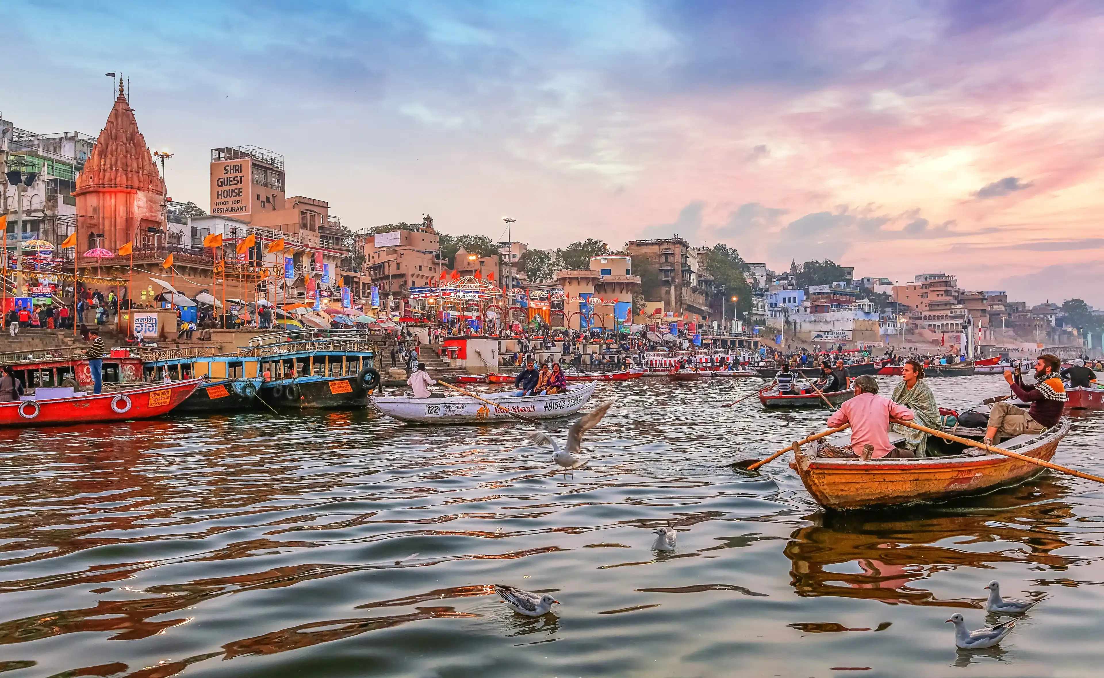 Varanasi, India, January 23,2019: Dashaswamedh Ganges river ghat Varanasi at twilight with tourists enjoying boating rides
