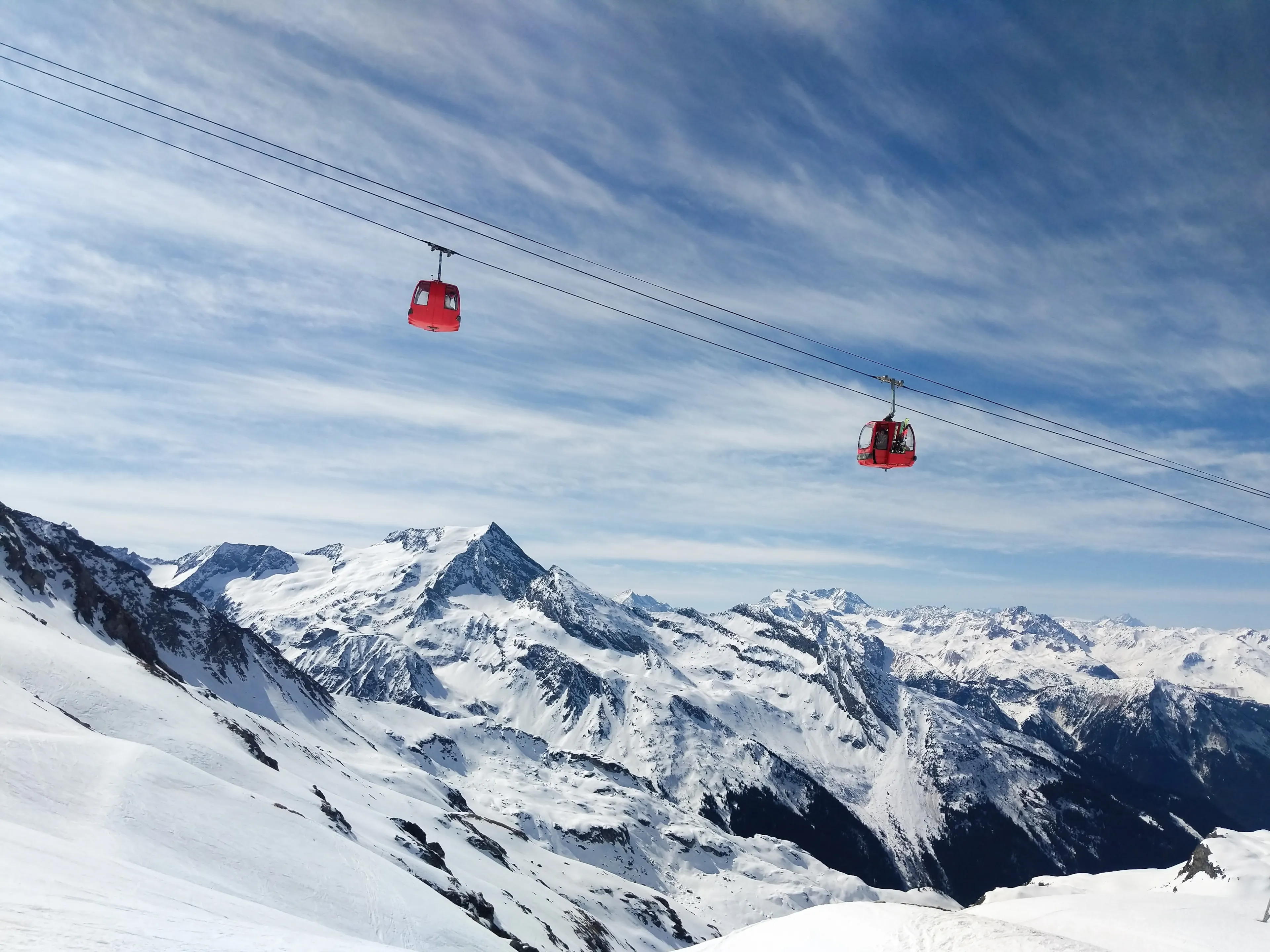 A beautiful view of the La Plagne glacier cable car on a sunny day in Alpes, France