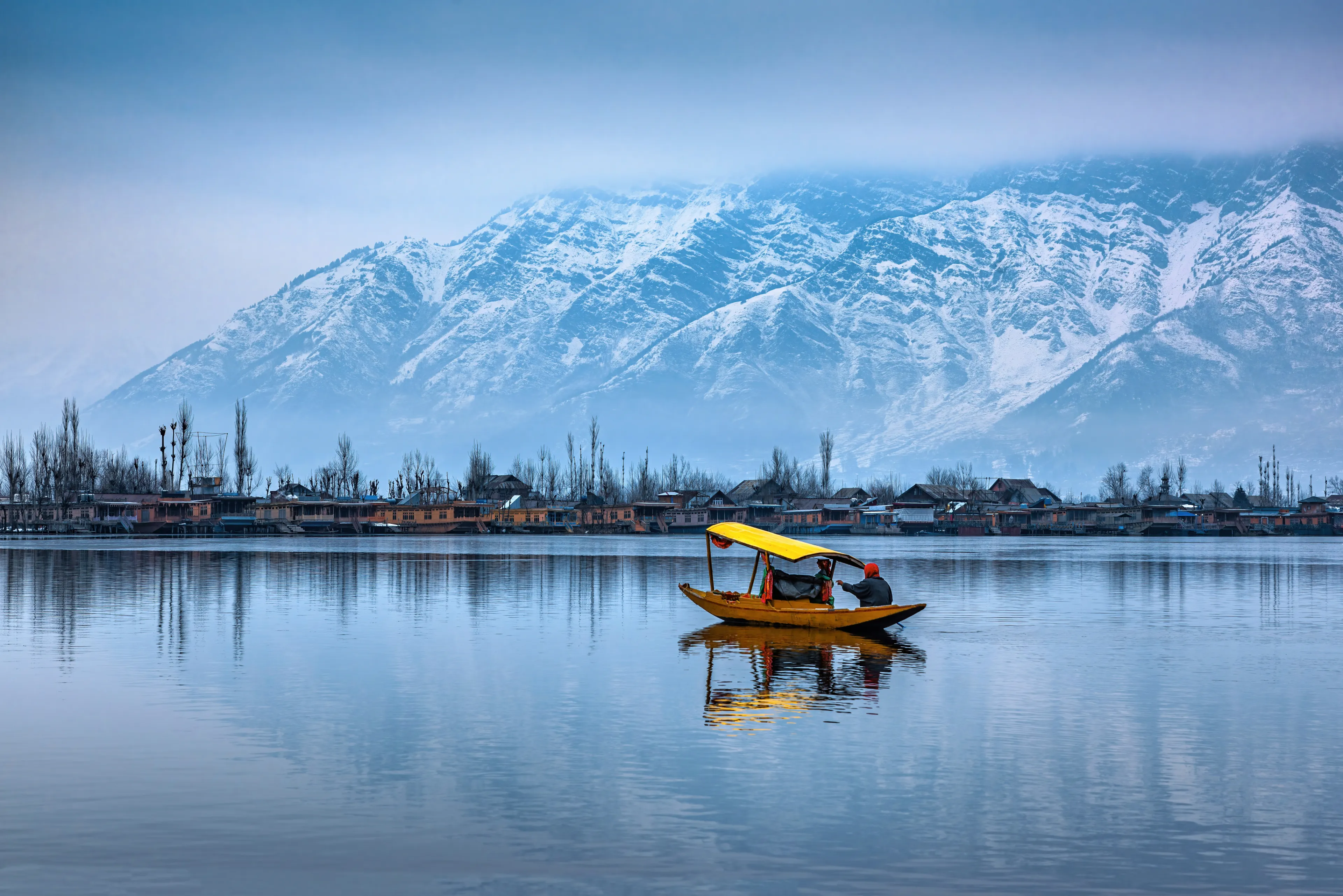 A view of Dal Lake in winter, and the beautiful mountain range in the background in the city of Srinagar, Kashmir, India.
