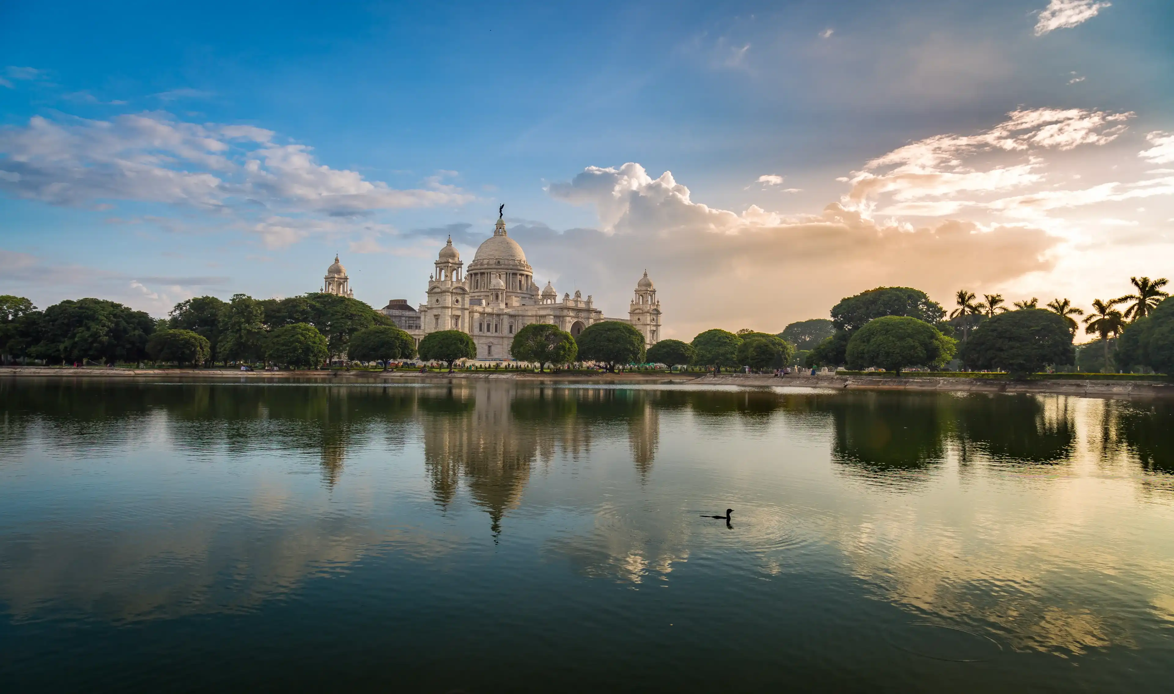 Victoria Memorial Kolkata at sunset with vibrant moody sky and mirror refections in water. Victoria Memorial is a monument and museum built in the memory of Queen Victoria in 1921 at Kolkata, India.