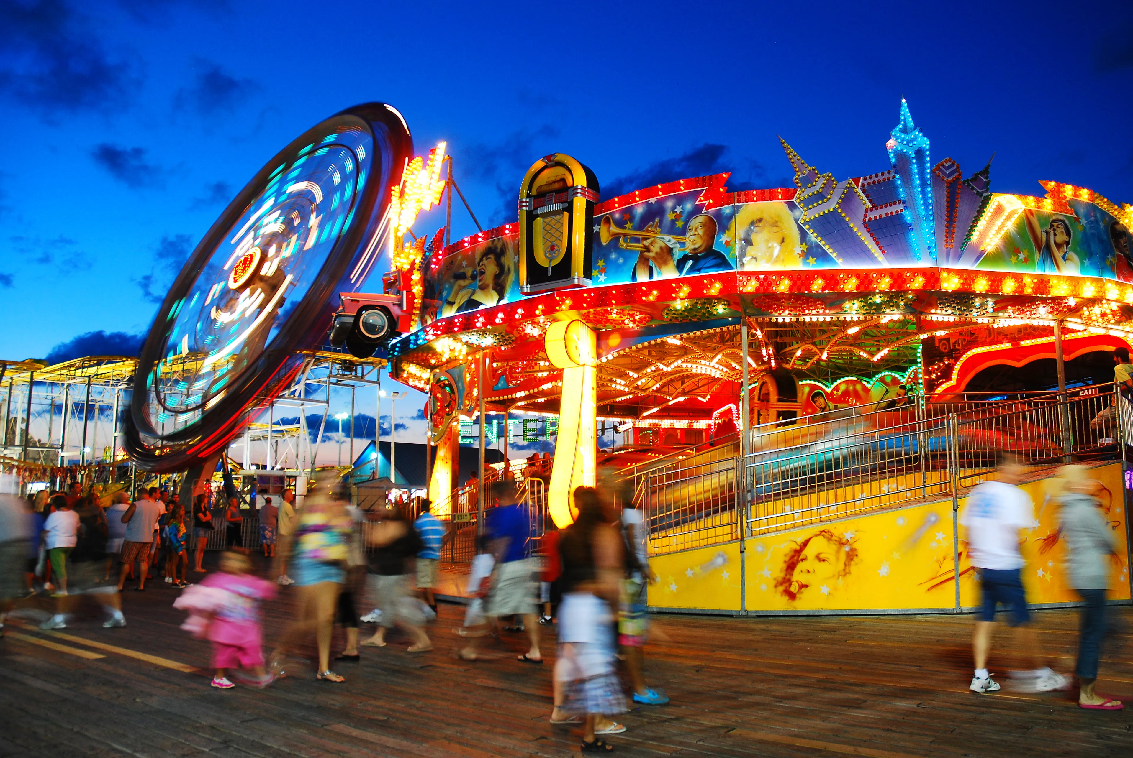 Seaside Heights, NJ, USA August 14 The lights of the Casino Pier Amusement Park Rides glow on a summer's night. The Seaside Heights New Jersey pier would later be destroyed by Hurricane Sandy