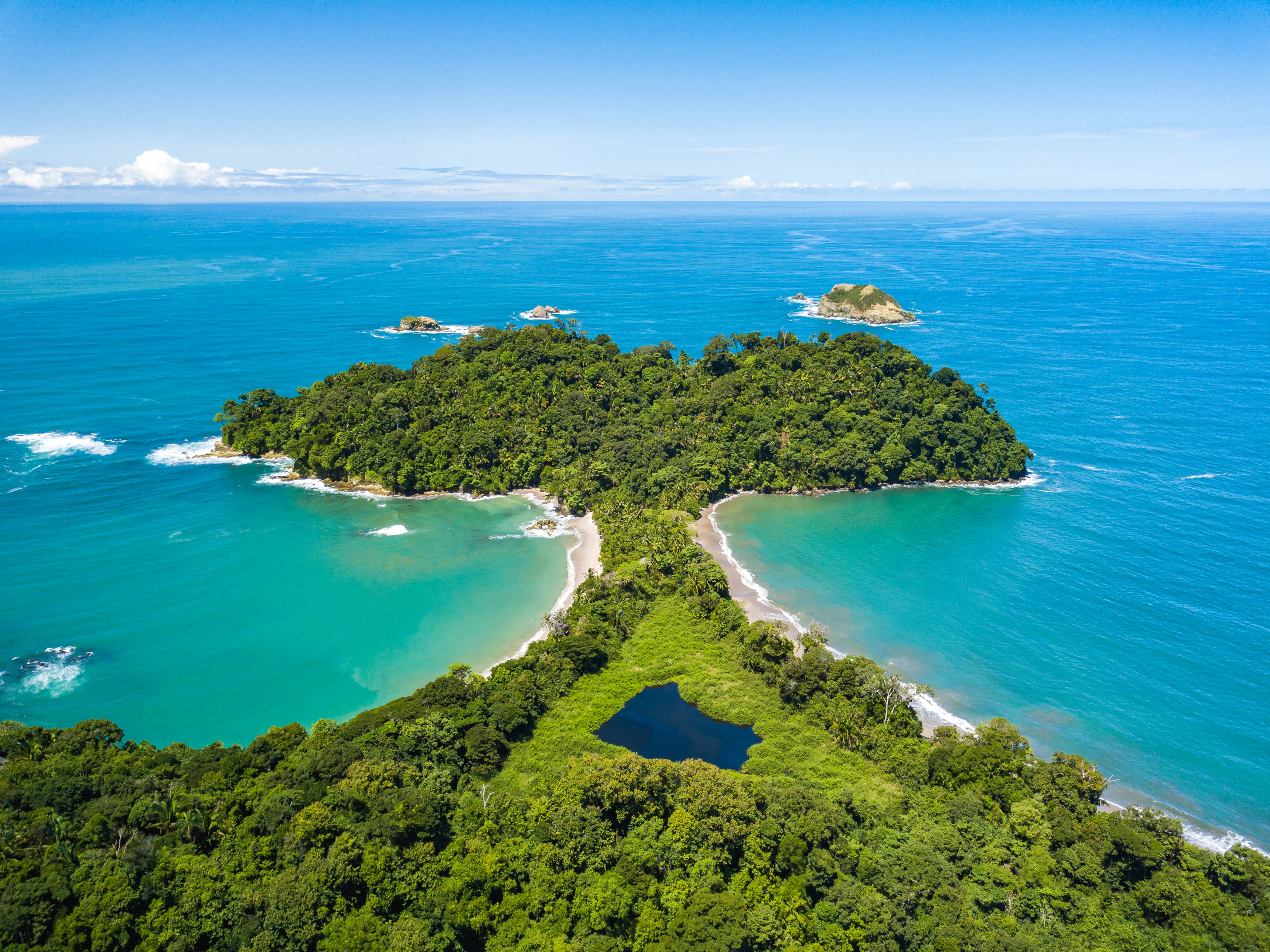 Aerial Drone view of Manuel Antonio National Park in Costa Rica. The best Tourist Attraction and Nature Reserve with lots of Wildlife, Tropical Plants and paradisiacal Beaches on the Pacific Coast.