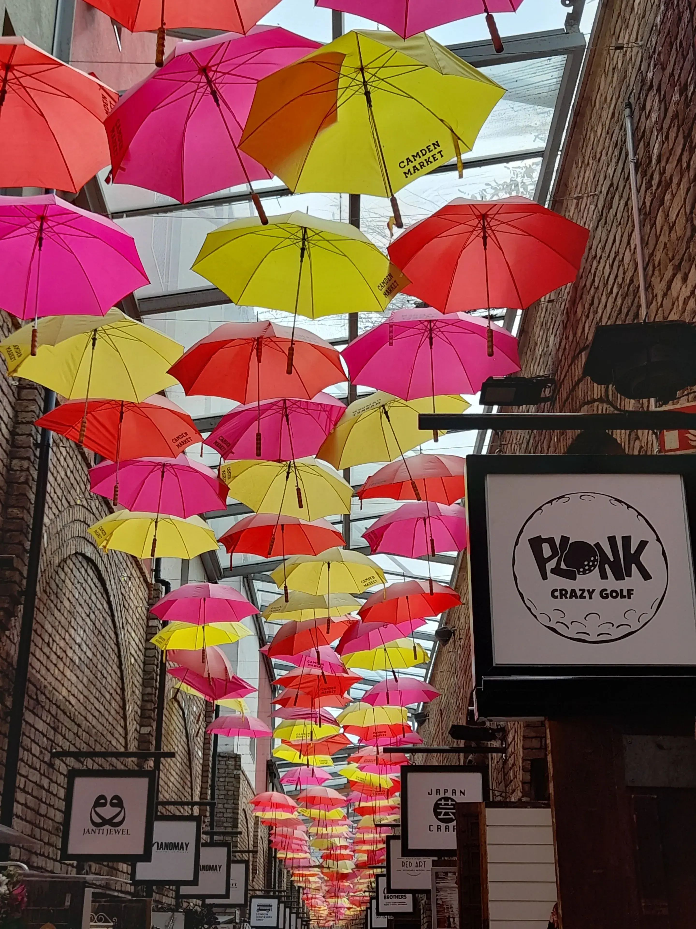 Colorful umbrellas hanging in Camden Market, creating a vibrant artistic scene Colorful umbrellas hanging in Camden Market, creating a vibrant artistic scene