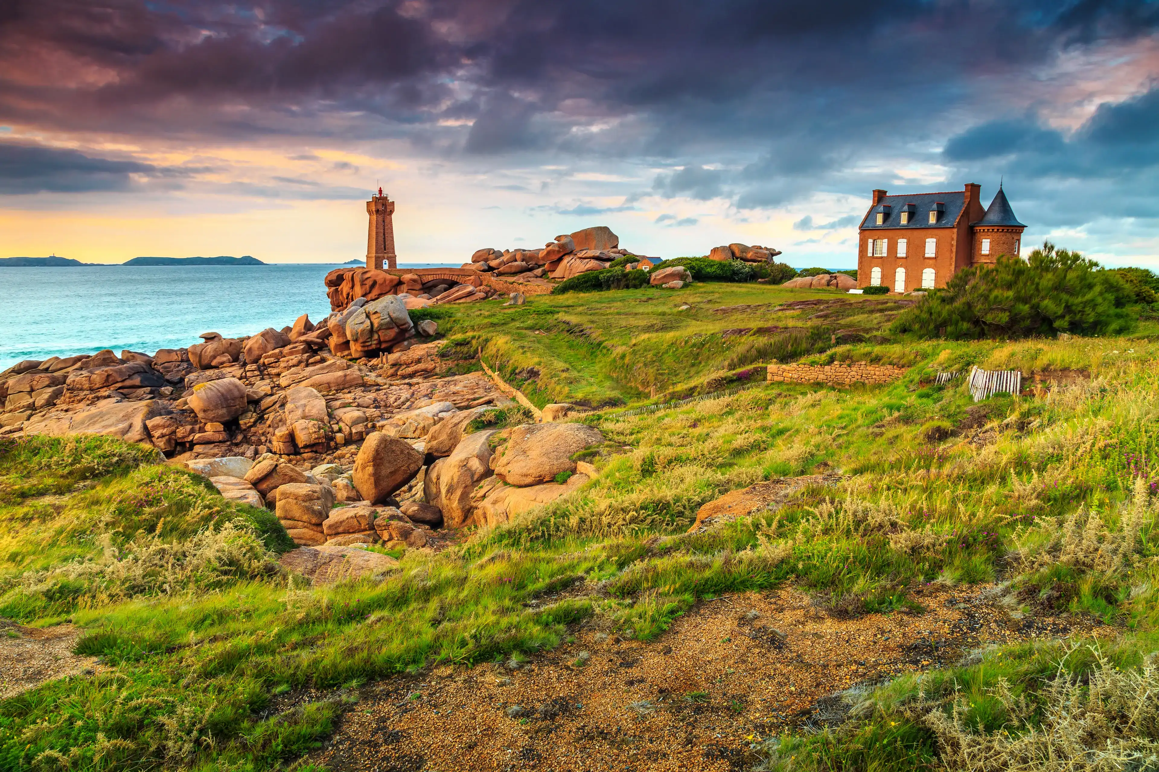 Amazing sunset with lighthouse of Ploumanach Mean Ruz in Perros-Guirec on Pink Granite Coast,Brittany,France,Europe