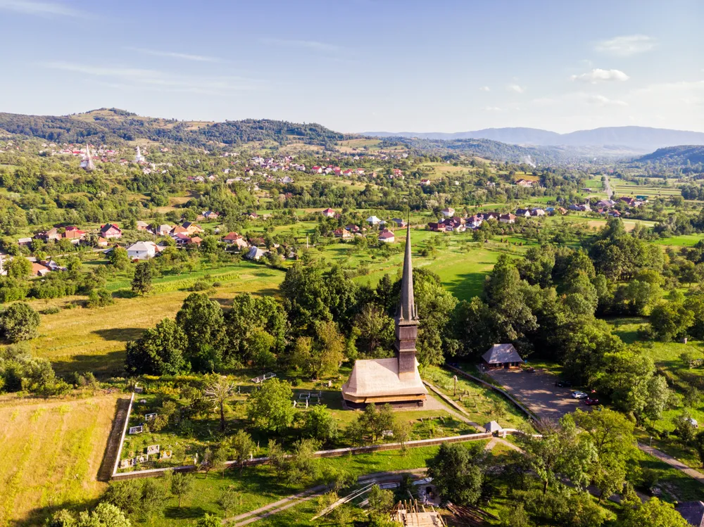 Beautiful aerial view on the Church of the Archangels Michael and Gabriel in Surdesti, Maramures County near Baia Mare, Romania. Traditional Maramures wooden architecture. UNESCO world heritage site.