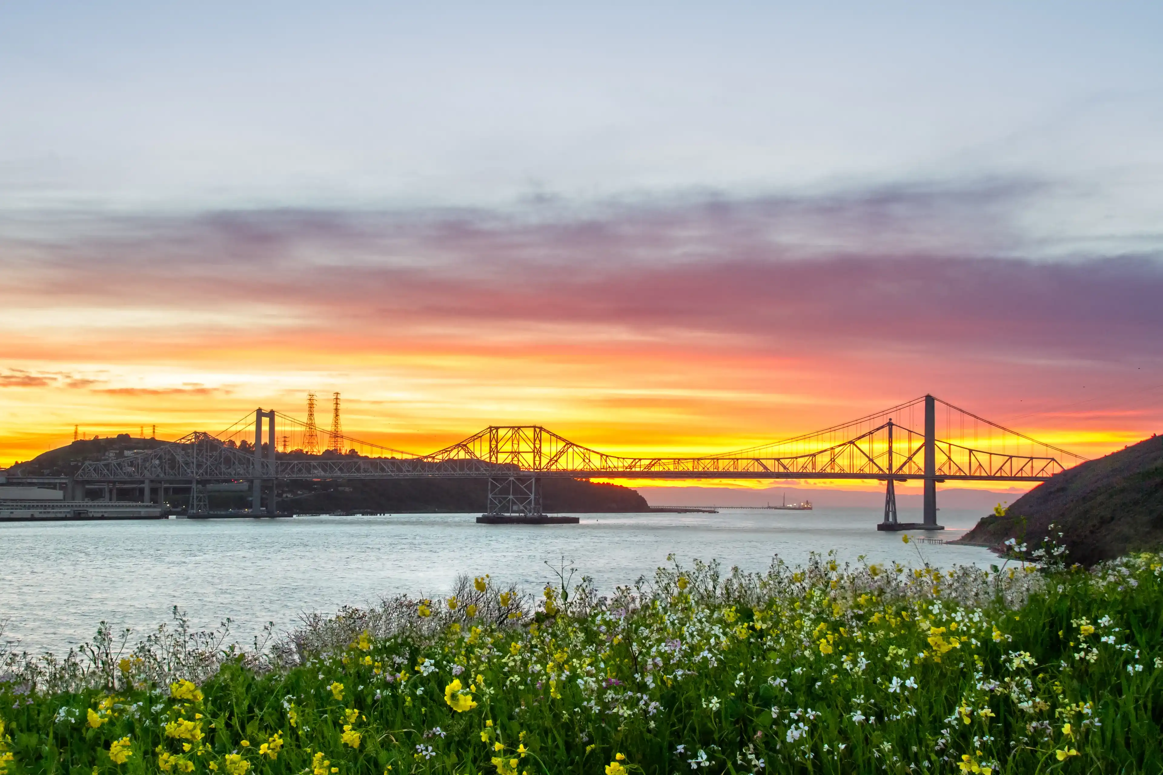 Sunset lights up the sky behind the Carquinez bridge in the Bay area of California. 