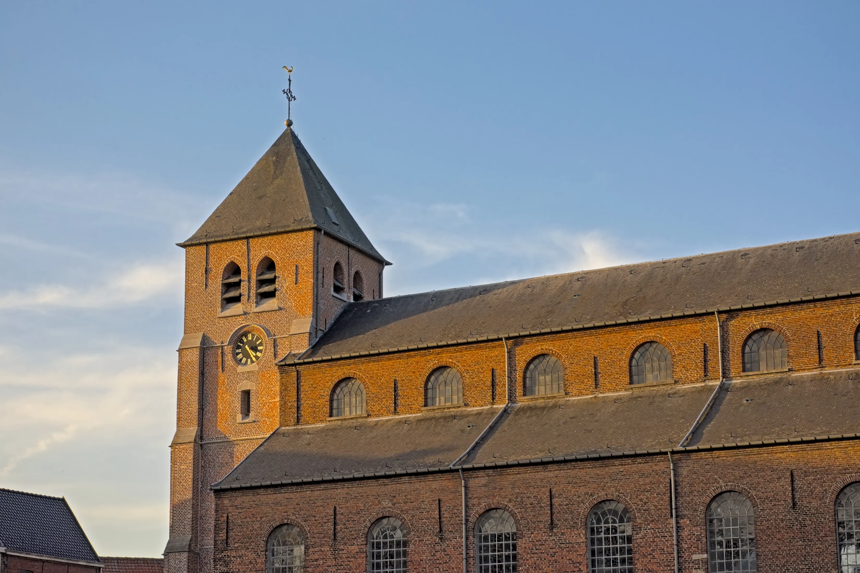 Clock tower of Saint Britius historical parish church in the village of Etikhove, Oudenaarde, Flanders, Belgium 