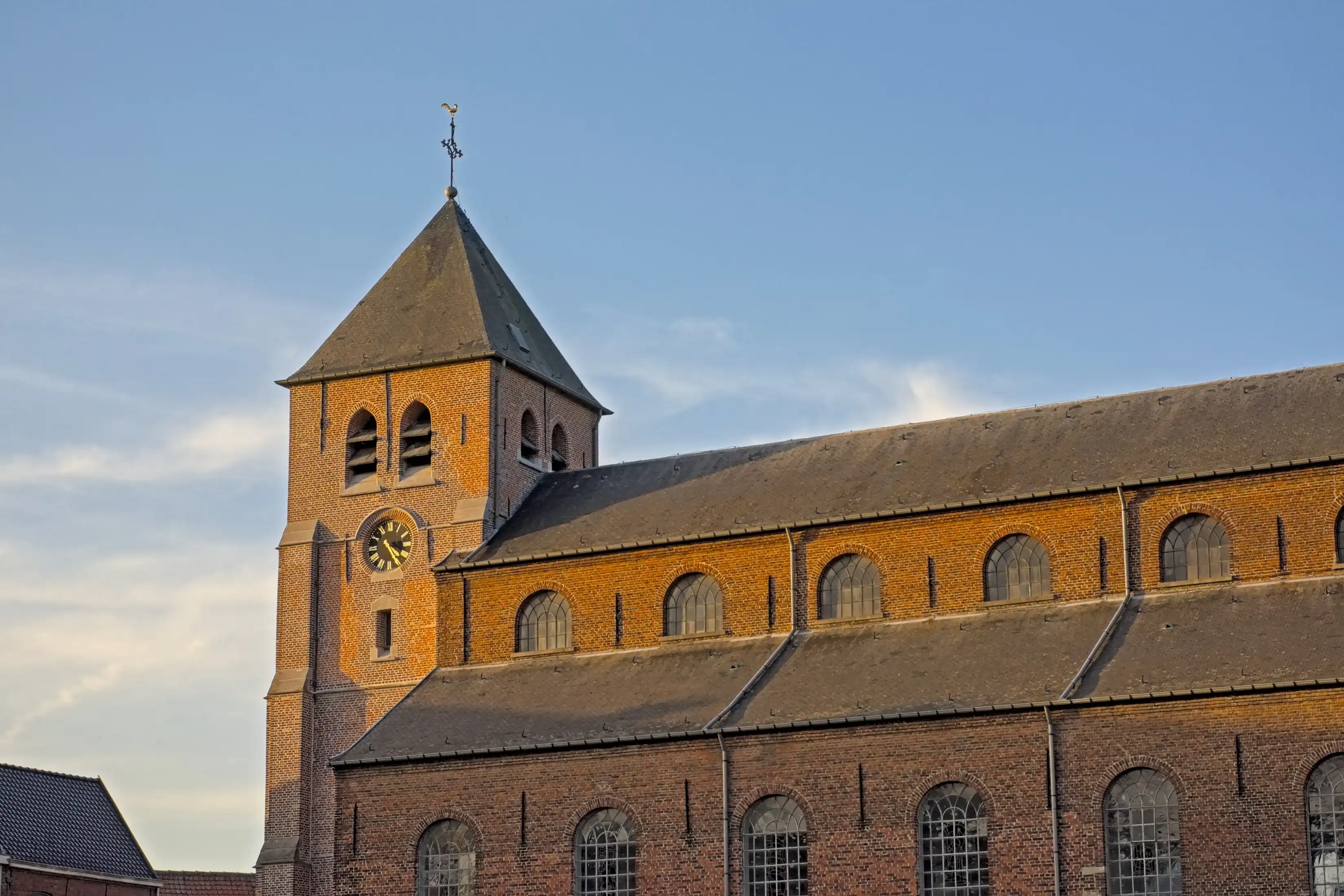Clock tower of Saint Britius historical parish church in the village of Etikhove, Oudenaarde, Flanders, Belgium 