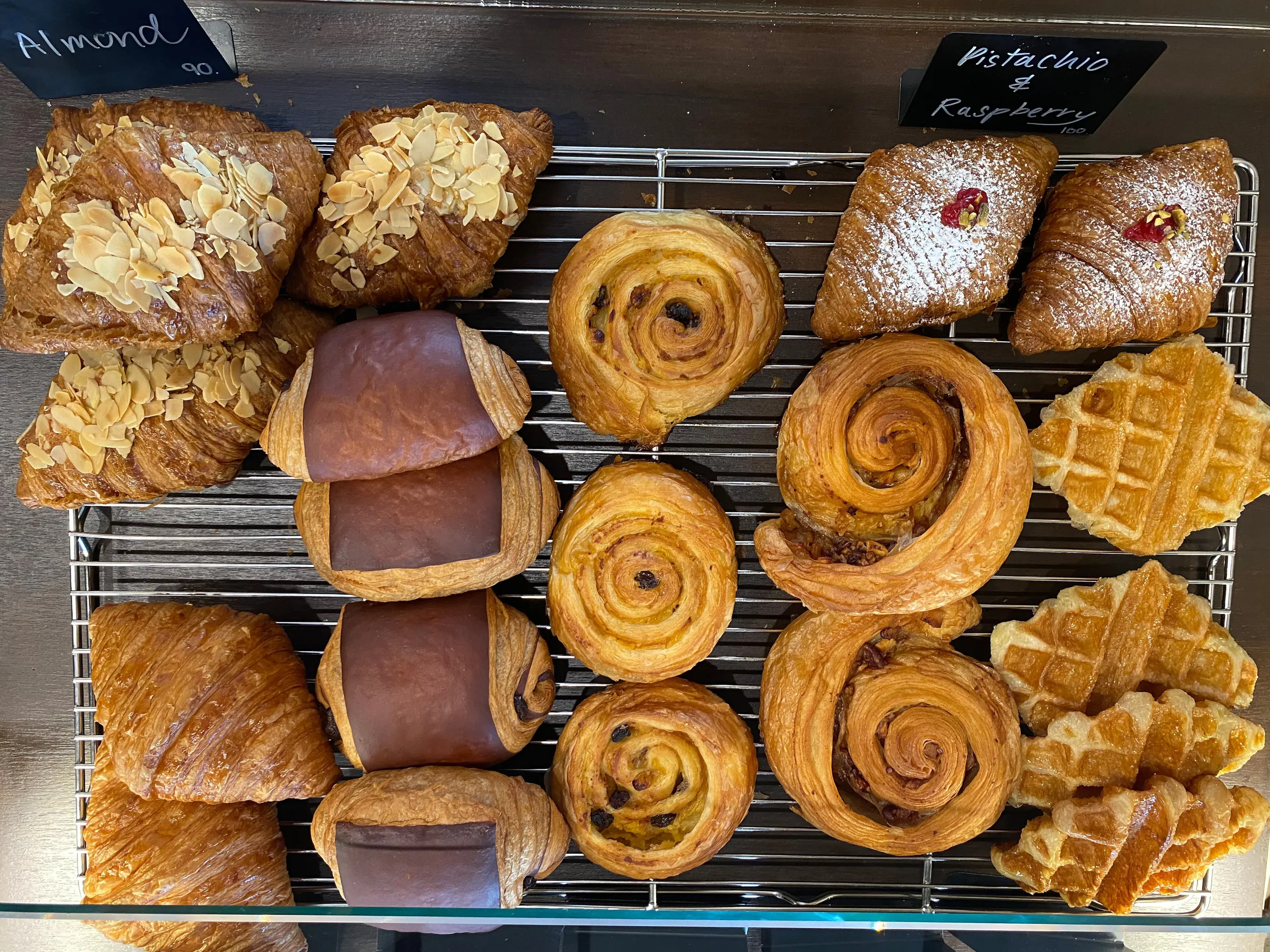 Display shelf of assorted bakery and pastry goods- Croissant and Danish rolls