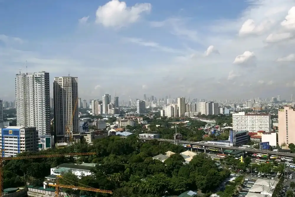 QUEZON CITY, PHILIPPINES - JULY 21, 2016: A bird's eye view of the commercial and residential buildings and structures in Quezon City, Philippines. QUEZON CITY, PHILIPPINES - JULY 21, 2016: A bird's eye view of the commercial and residential buildings and structures in Quezon City, Philippines.