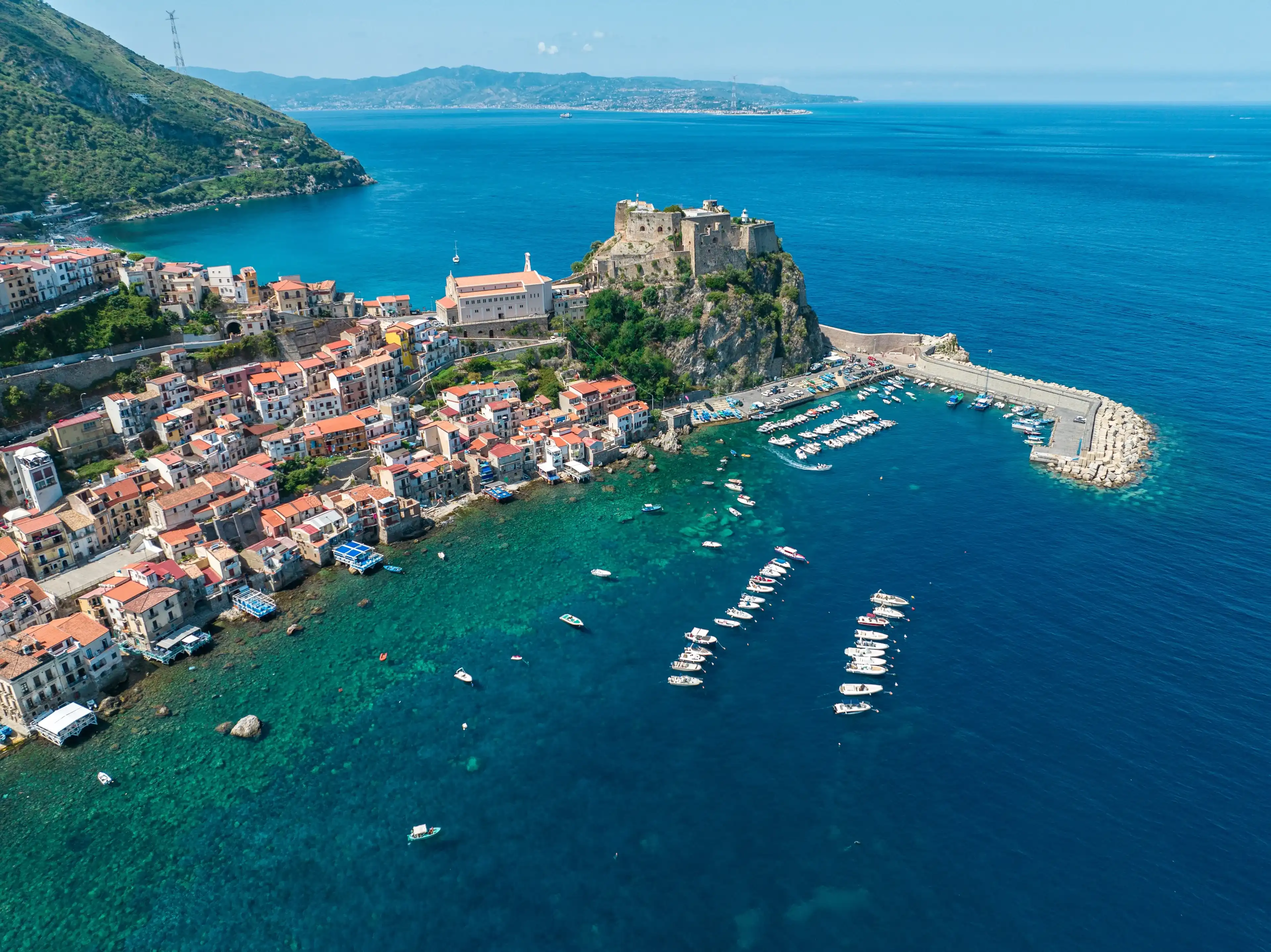 Aerial view of Scilla, Reggio Calabria, Calabria. Promontory at the northern entrance of the Strait of Messina. Ruffo Castle and lighthouse. Tyrrhenian Sea. Italy Aerial view of Scilla, Reggio Calabria, Calabria. Promontory at the northern entrance of the Strait of Messina. Ruffo Castle and lighthouse. Tyrrhenian Sea. Italy