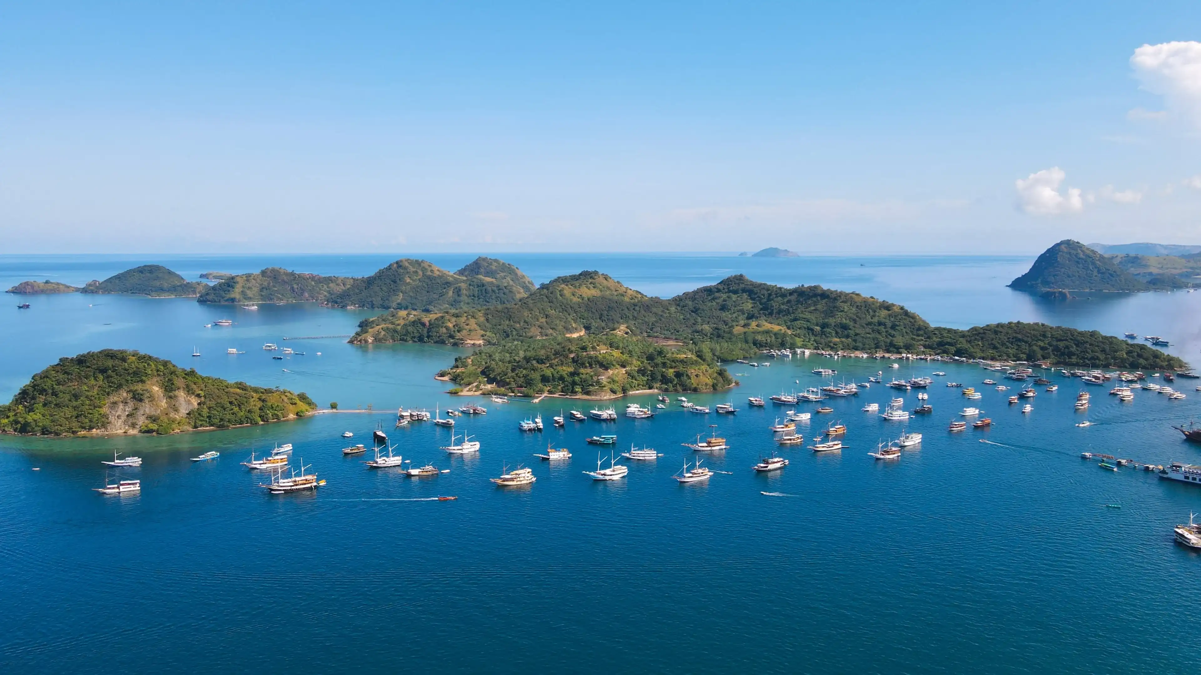 Labuan Bajo Flores Indonesia a panoramic landscape. Super premium city in Indonesia. Sea and tourist boats blue sky and city buildings. From this city is Komodo Dragon boat trip begins. 