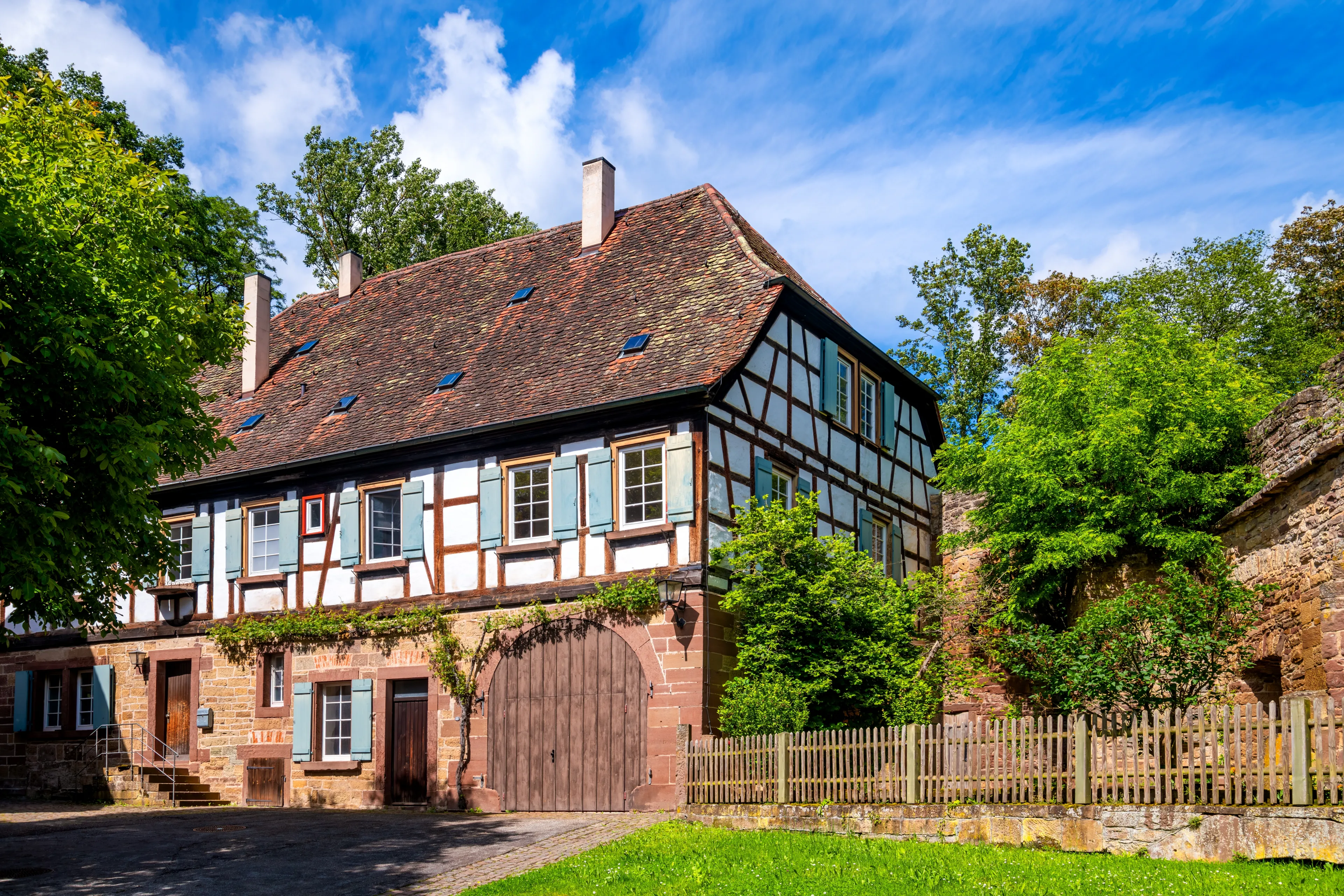 Historic half-timbered house with red sandstone foundations in idyllic surroundings in Maulbronn, Baden-Württemberg (Germany). Renovated old building with beautiful garden. Near the monastery sight.