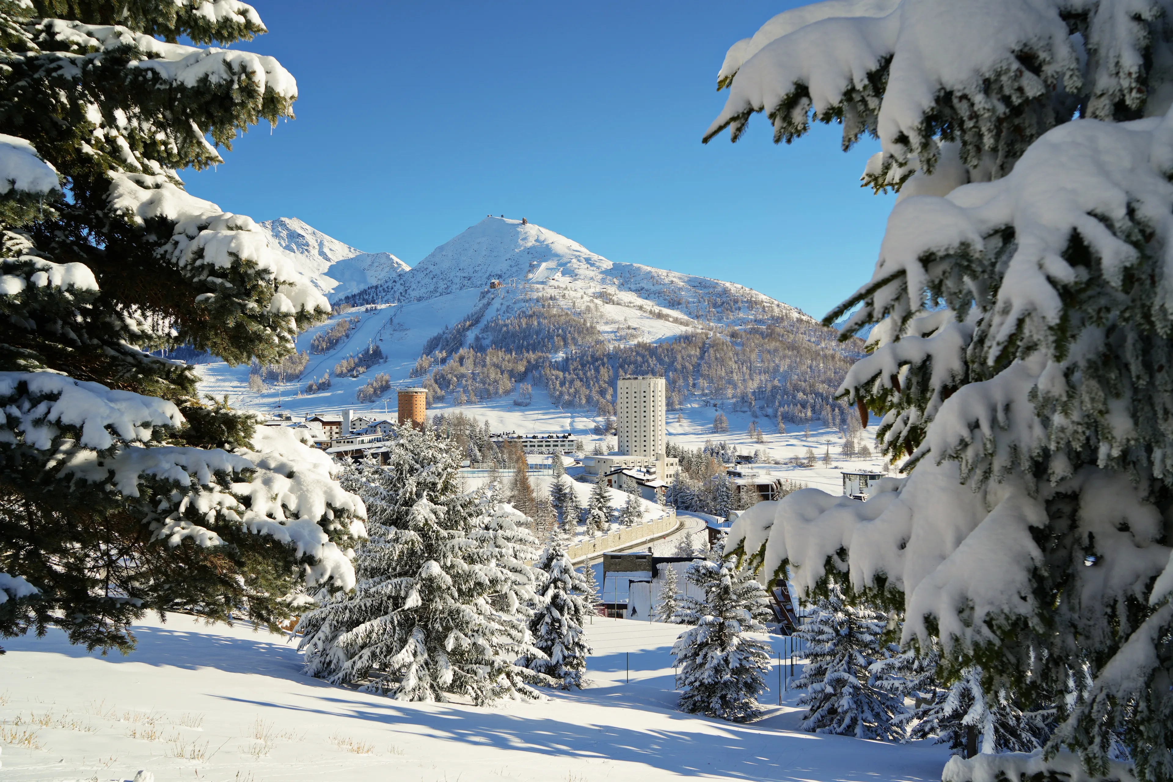 Overview of the snow-covered alpine village of Sestriere, which was the site of the Winter Olympics in 2006. Sestriere, Italy - December 2022