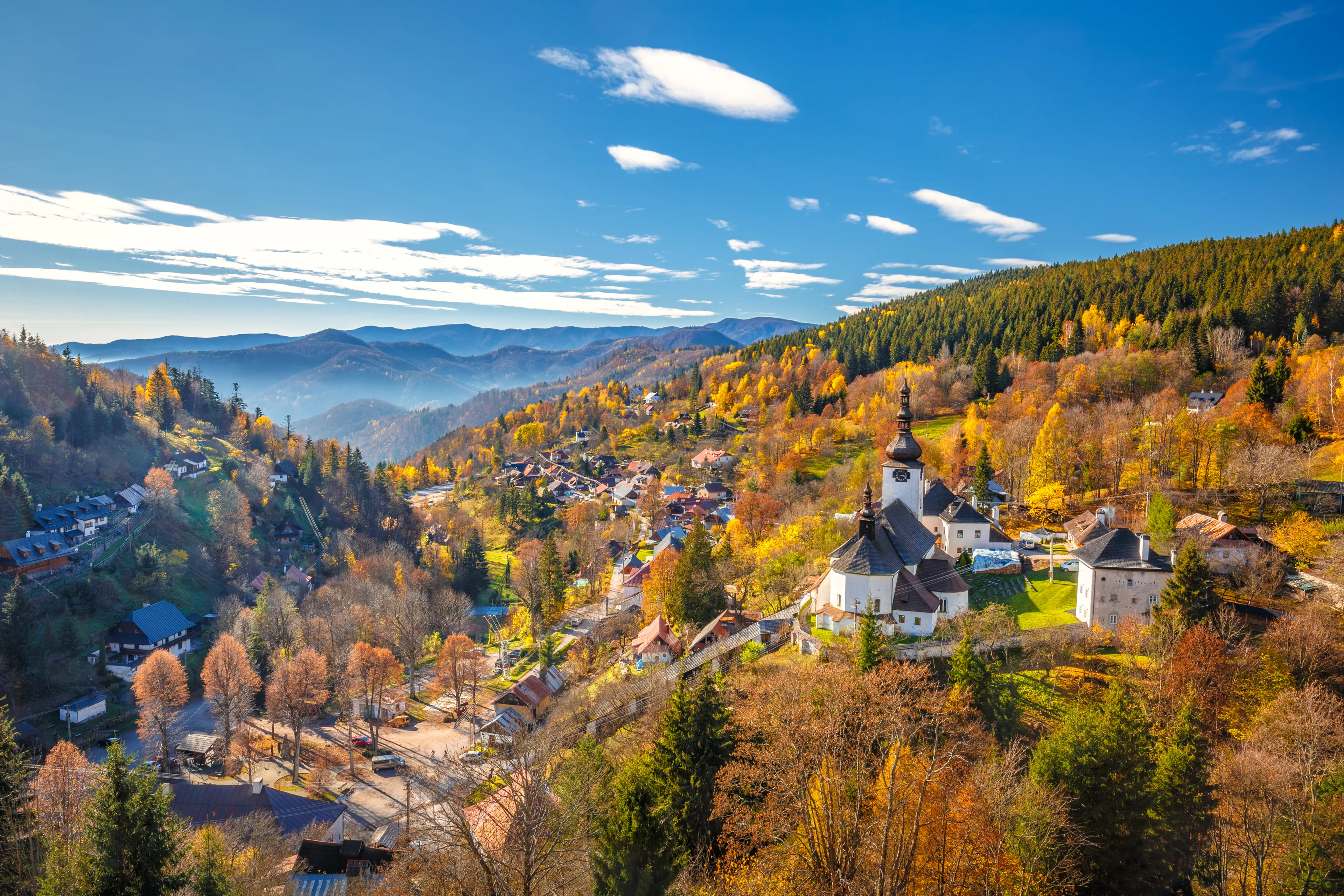 The Spania Dolina village with church and historic buildings in valley of autumn  landscape, Slovakia, Europe.