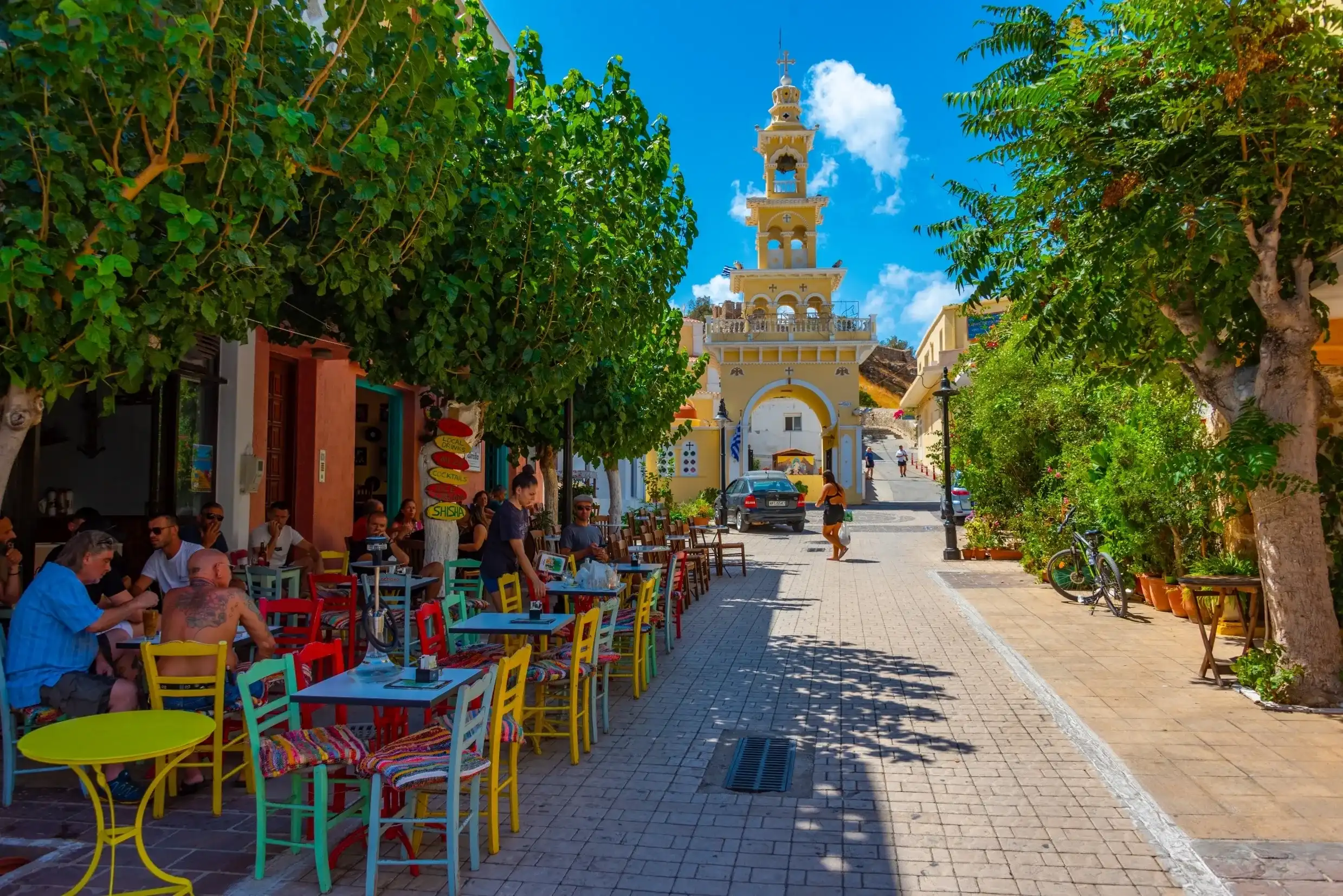 Palaiochora, Greece, August 21, 2022: People are strolling at a tourist street in Greek town Palaiochora at Crete island. Palaiochora, Greece, August 21, 2022: People are strolling at a tourist street in Greek town Palaiochora at Crete island.