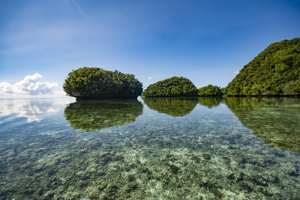 Sky, reflection, small islands and Ocean, Rock Islands Southern Lagoon, World heritage site in Koror state, Palau
