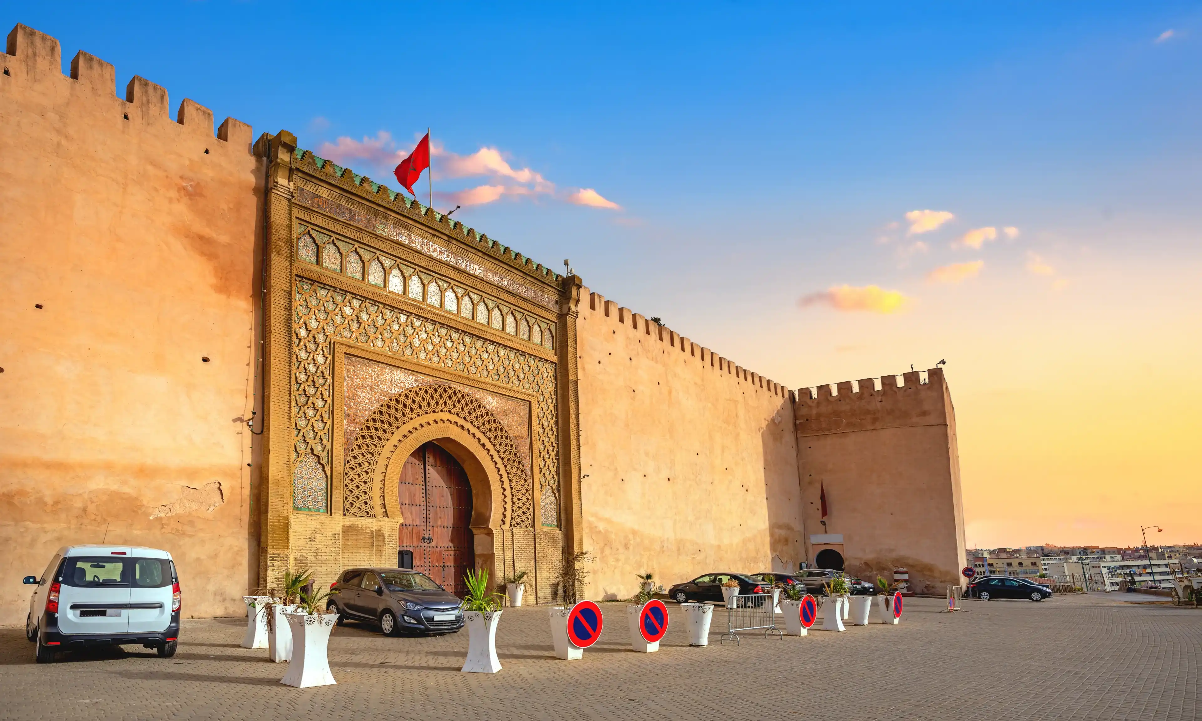 View of El Hedim square with ancient gate Bab El-Mansour and ancient walls in Meknes. Morocco, North Africa View of El Hedim square with ancient gate Bab El-Mansour and ancient walls in Meknes. Morocco, North Africa