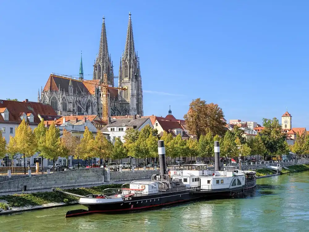 Regensburg Cathedral and old steamship at the shore of Danube river in Regensburg, Germany