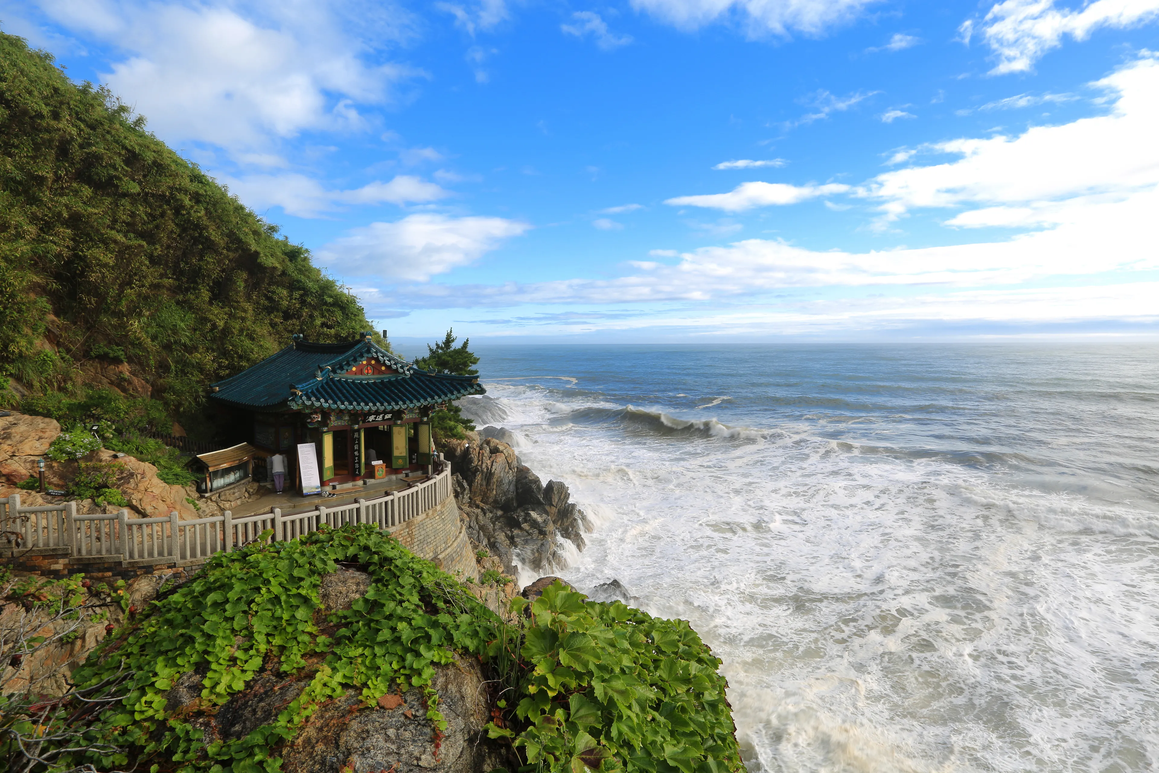 Yangyang-gun, Gangwon-do, Korea - August 16, 2019:Hongnyeonam Hermitage of Naksansa Temple on cliff with big waves of the sea. This temple was built by the monk 'Uisang' of Silla era on the seashore 