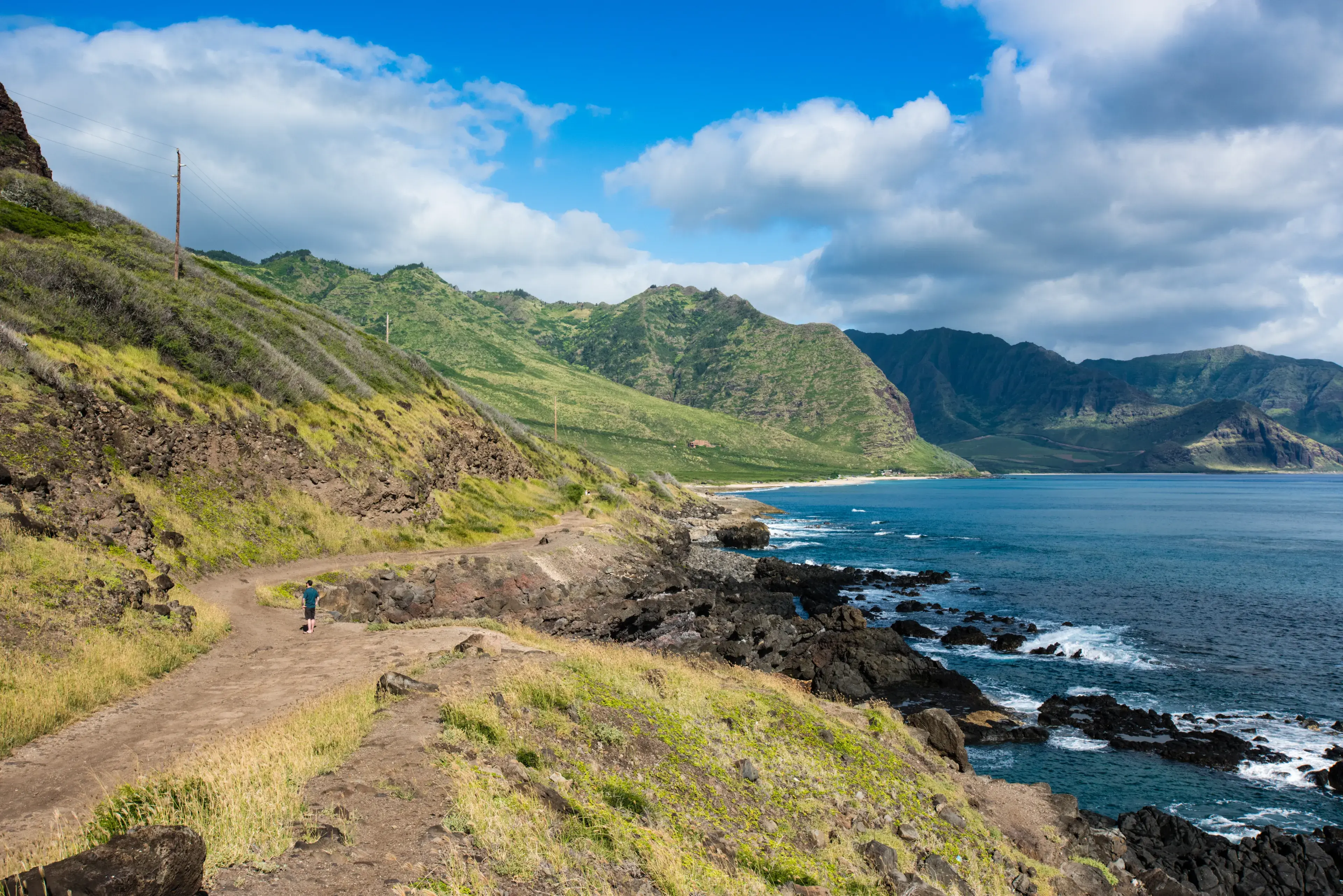 Hiker on Ka'ena Point Trail, Oahu, Hawaii Hiker on Ka'ena Point Trail, Oahu, Hawaii