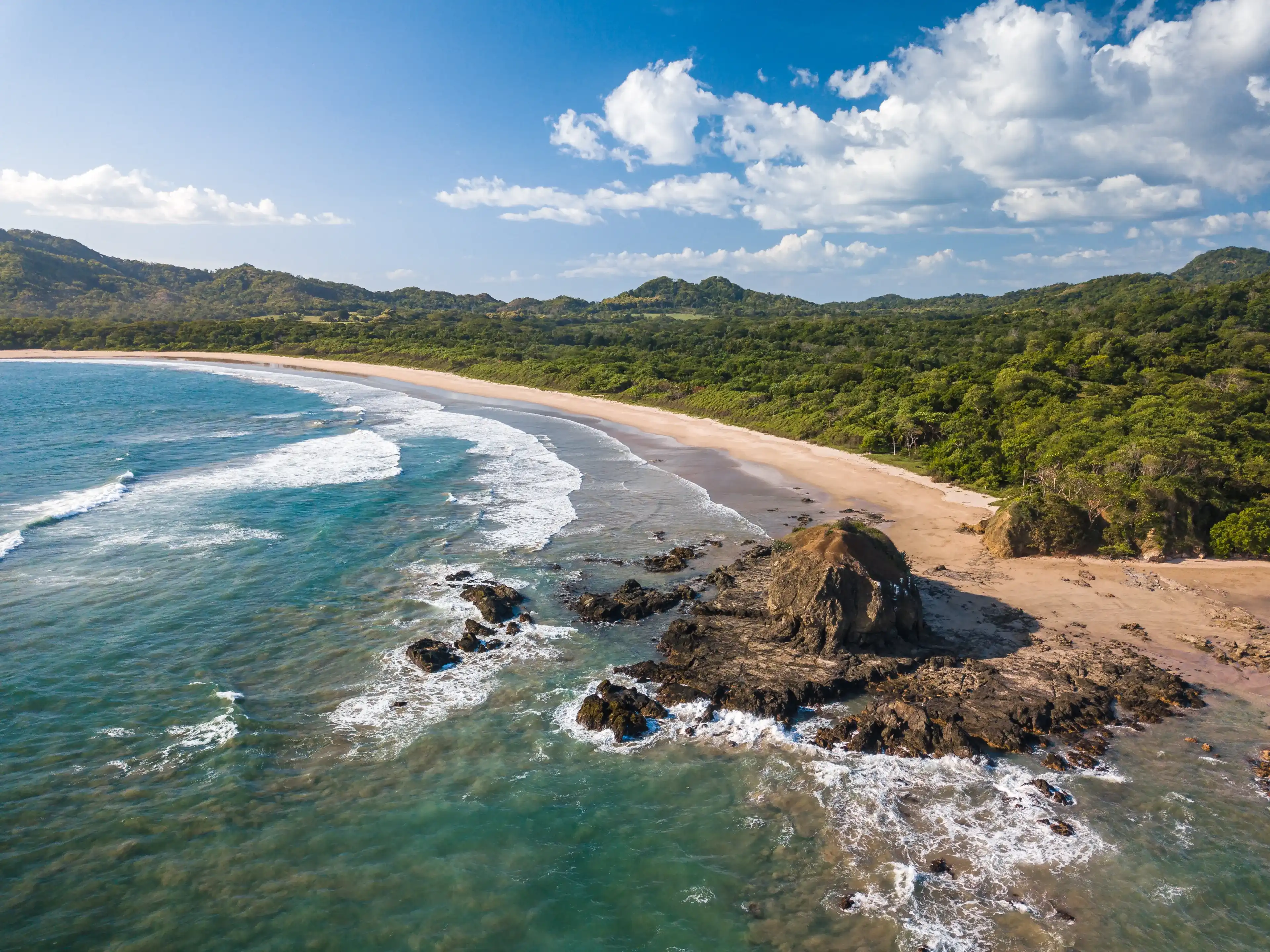 Playa Grande, Guanacaste, Costa Rica - Aerial View of most famous Surfer Beach with big Waves and Rocks - Tropical Landscape of Las Baulas Marine National Park Playa Grande, Guanacaste, Costa Rica - Aerial View of most famous Surfer Beach with big Waves and Rocks - Tropical Landscape of Las Baulas Marine National Park