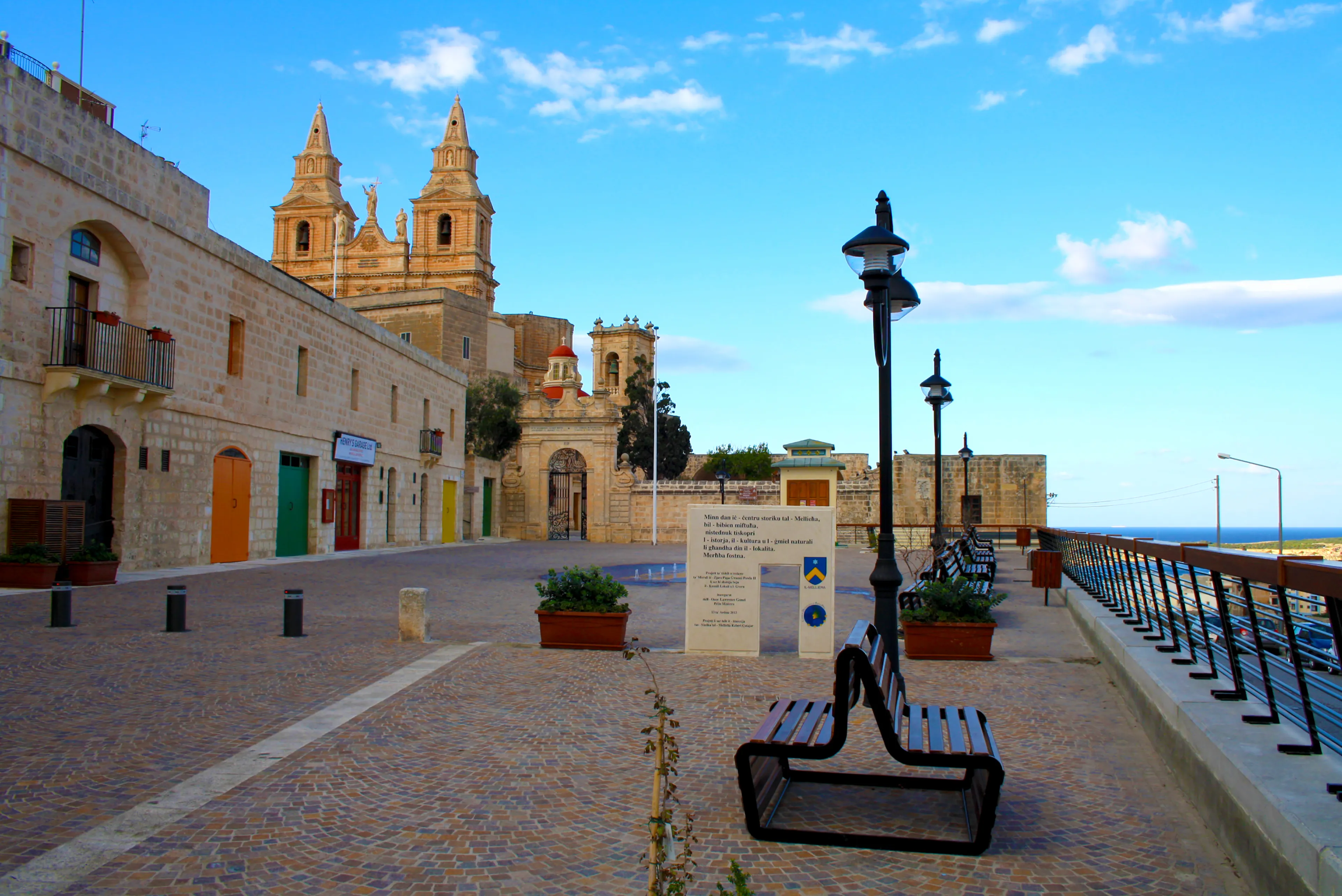 Mellieha, Malta - December 29, 2012: Wonderful outdoor patio at the bottom of the Sanctuary of Our Lady of Mellieħa with benches and a beautiful blue sky, Malta