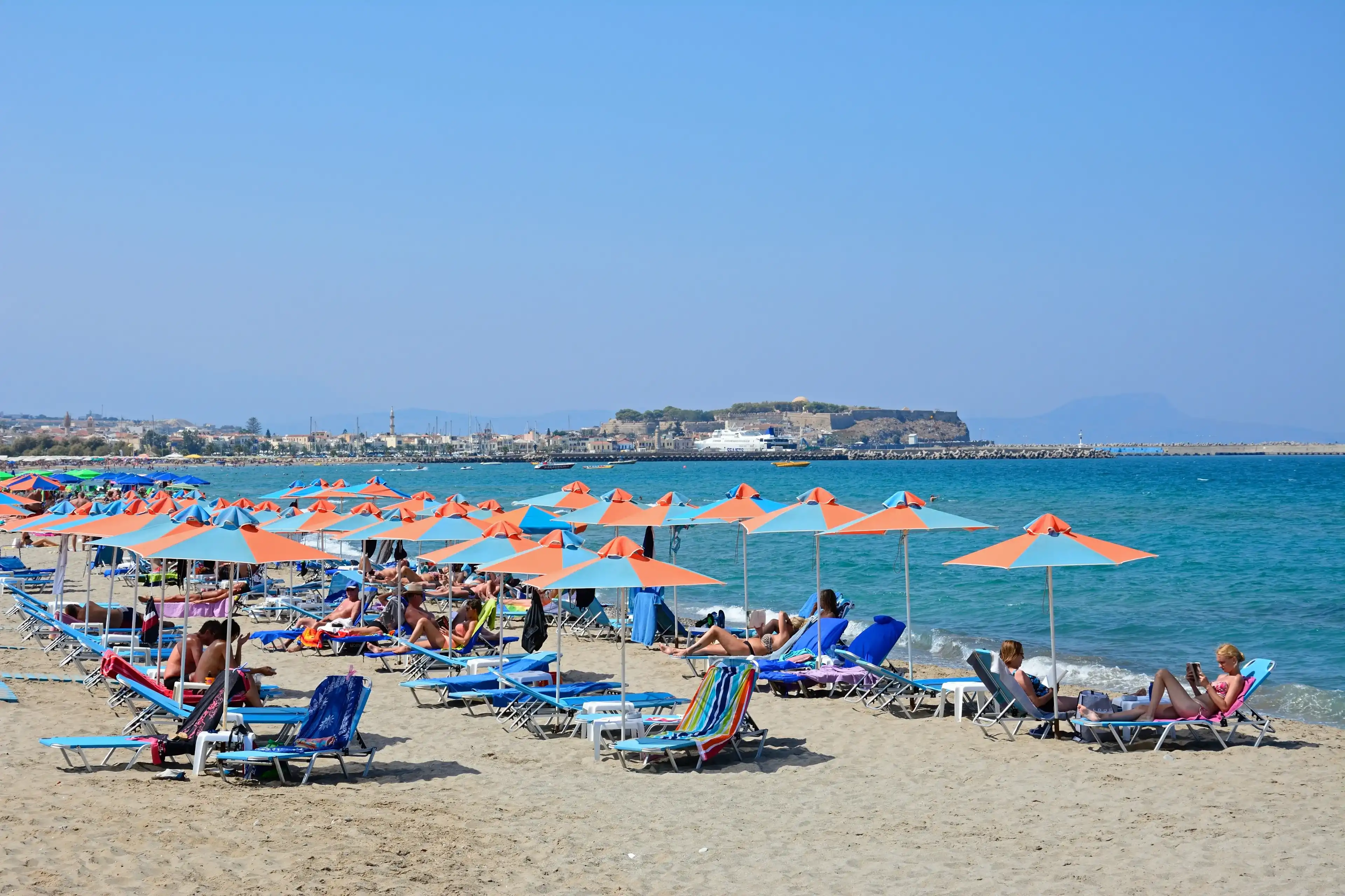 PERIVOLIA, CRETE - SEPTEMBER 15, 2016 - Tourists relaxing on the sandy beach, Perivolia, Crete, Greece, Europe, September 15, 2016. PERIVOLIA, CRETE - SEPTEMBER 15, 2016 - Tourists relaxing on the sandy beach, Perivolia, Crete, Greece, Europe, September 15, 2016.