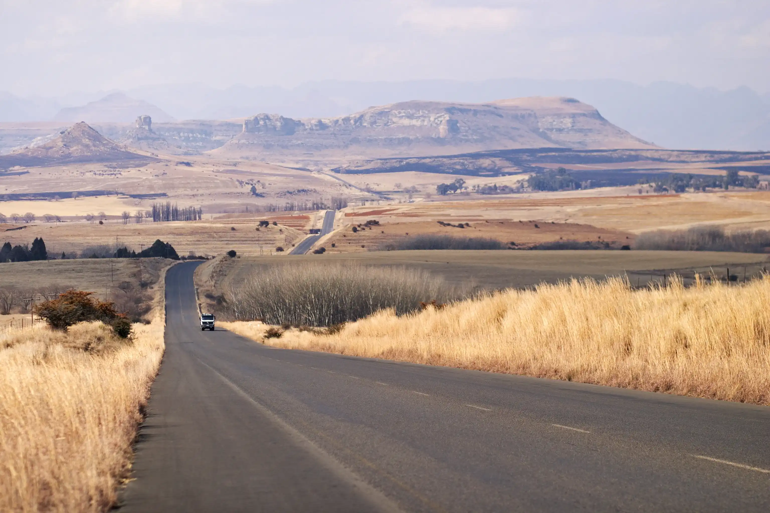 The road between Ficksburg and Clarens in South Africa runs through rolling winter farmlands.