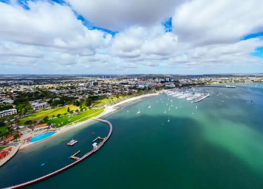 Aerial views from Port Phillip Bay towards Geelong CBD and Eastern Beach Children's Pool on a warm summer morning in Geelong, Victoria, Australia