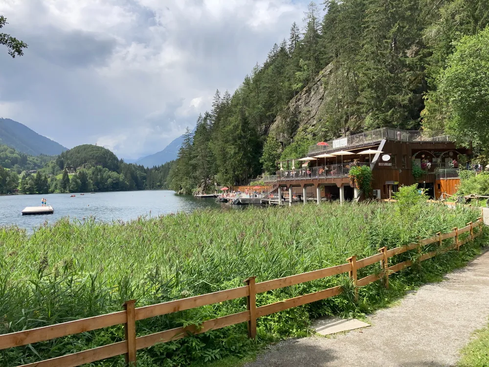 Piburger See, Oetz, Oetztal Valley, Tyrol, Austria - July 26, 2020: View over lake Piburger See and restaurant "Restaurant am See"