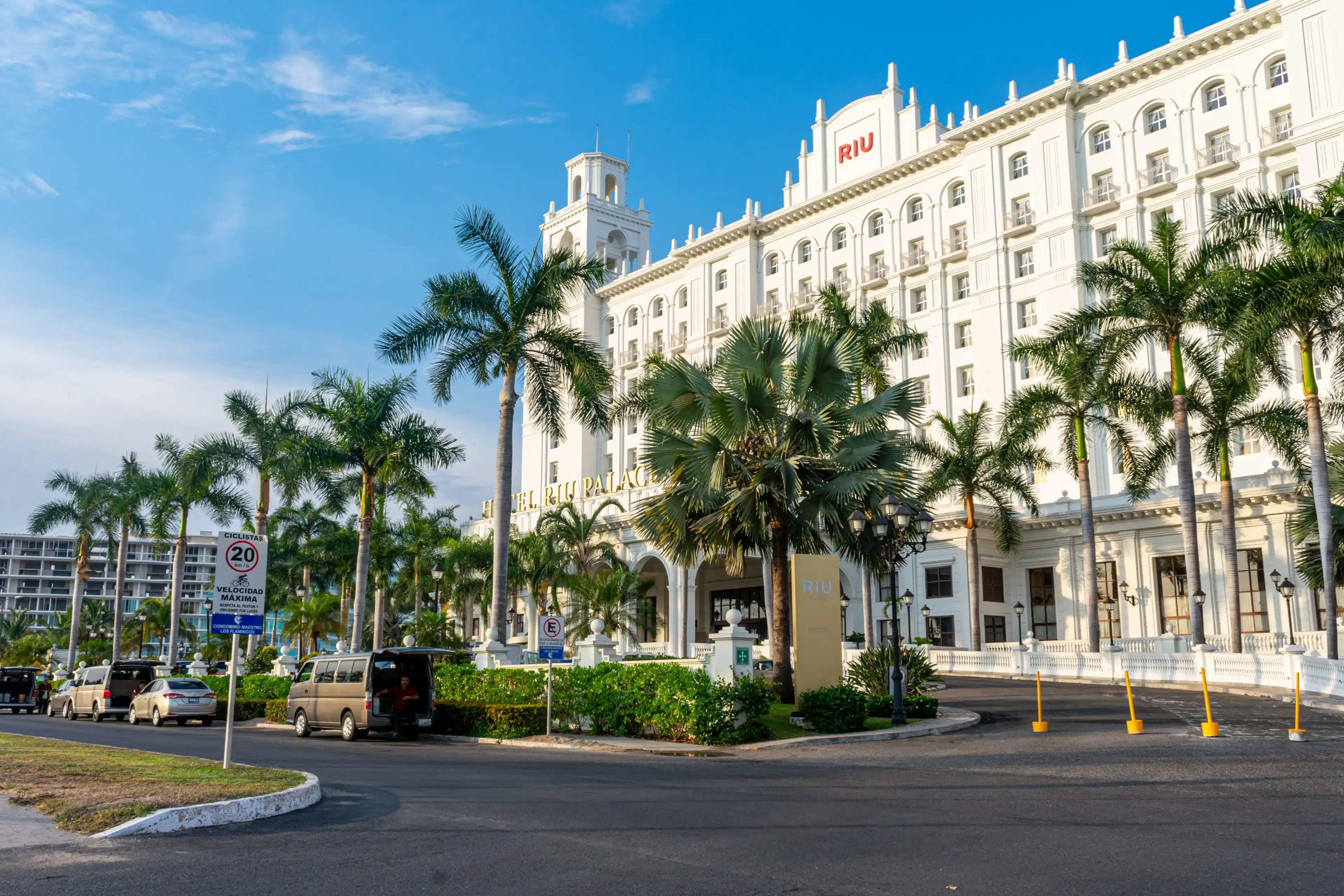 Nuevo Vallarta, Nayarit, Mexico - September 13, 2021: Facade Hotel Riu Palace and palm trees Nuevo Vallarta, Nayarit, Mexico - September 13, 2021: Facade Hotel Riu Palace and palm trees