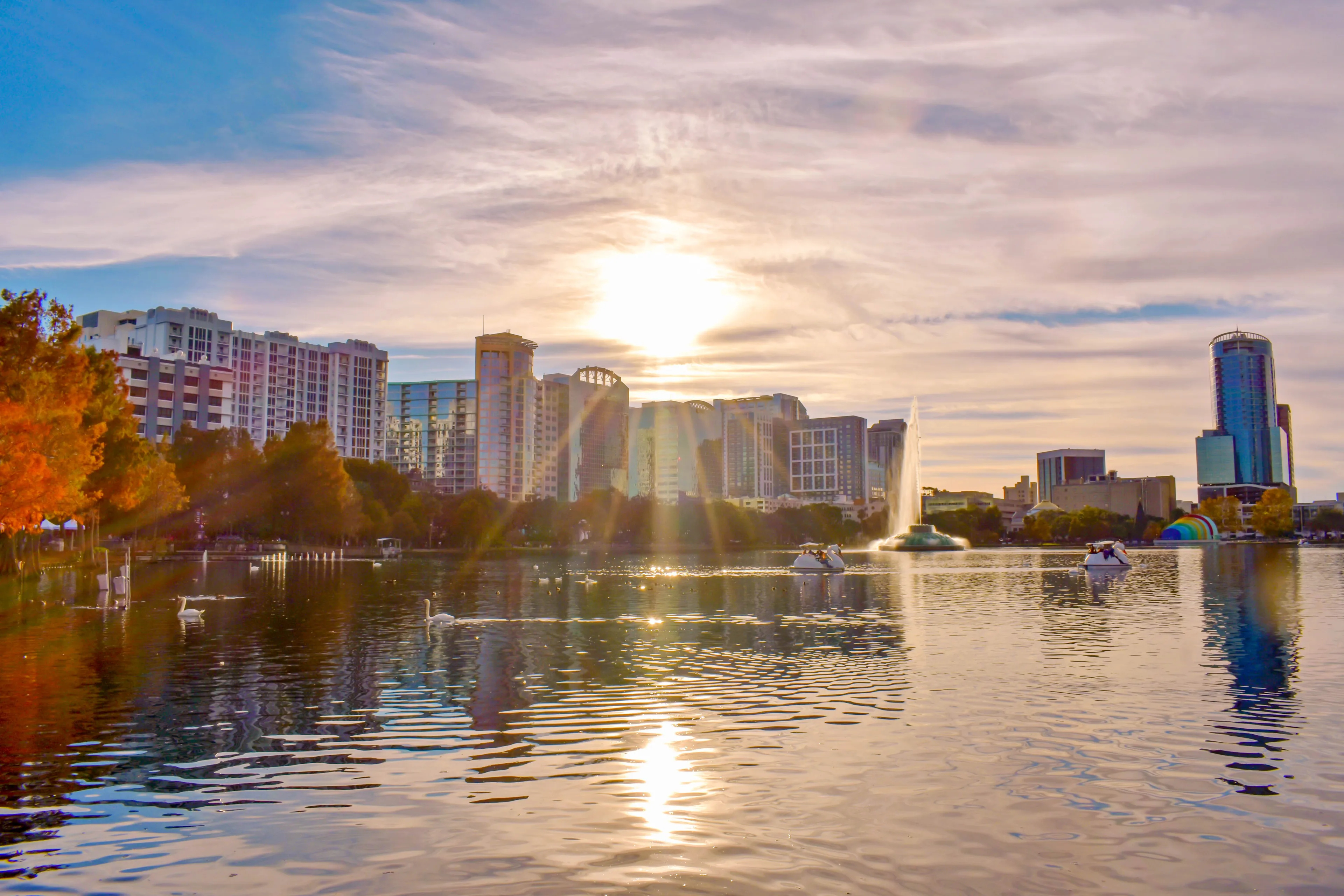 Orlando, Florida . December 24, 2018. Colorful buildings and autumn forest at Lake Eola Park on beautiful sunset background in Orlando Downtown area  (1)
