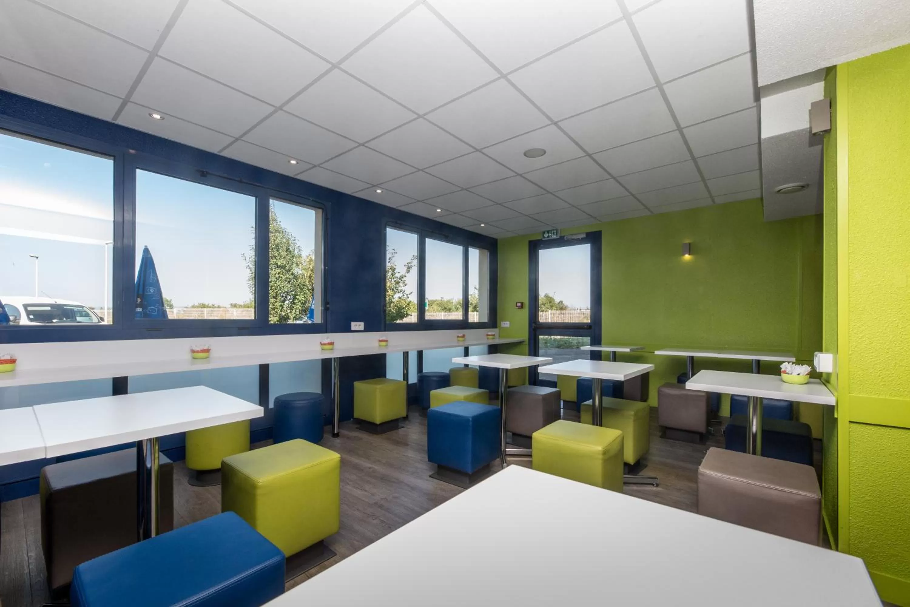 Communal lounge/ TV room in ibis budget Lyon Est Chaponnay